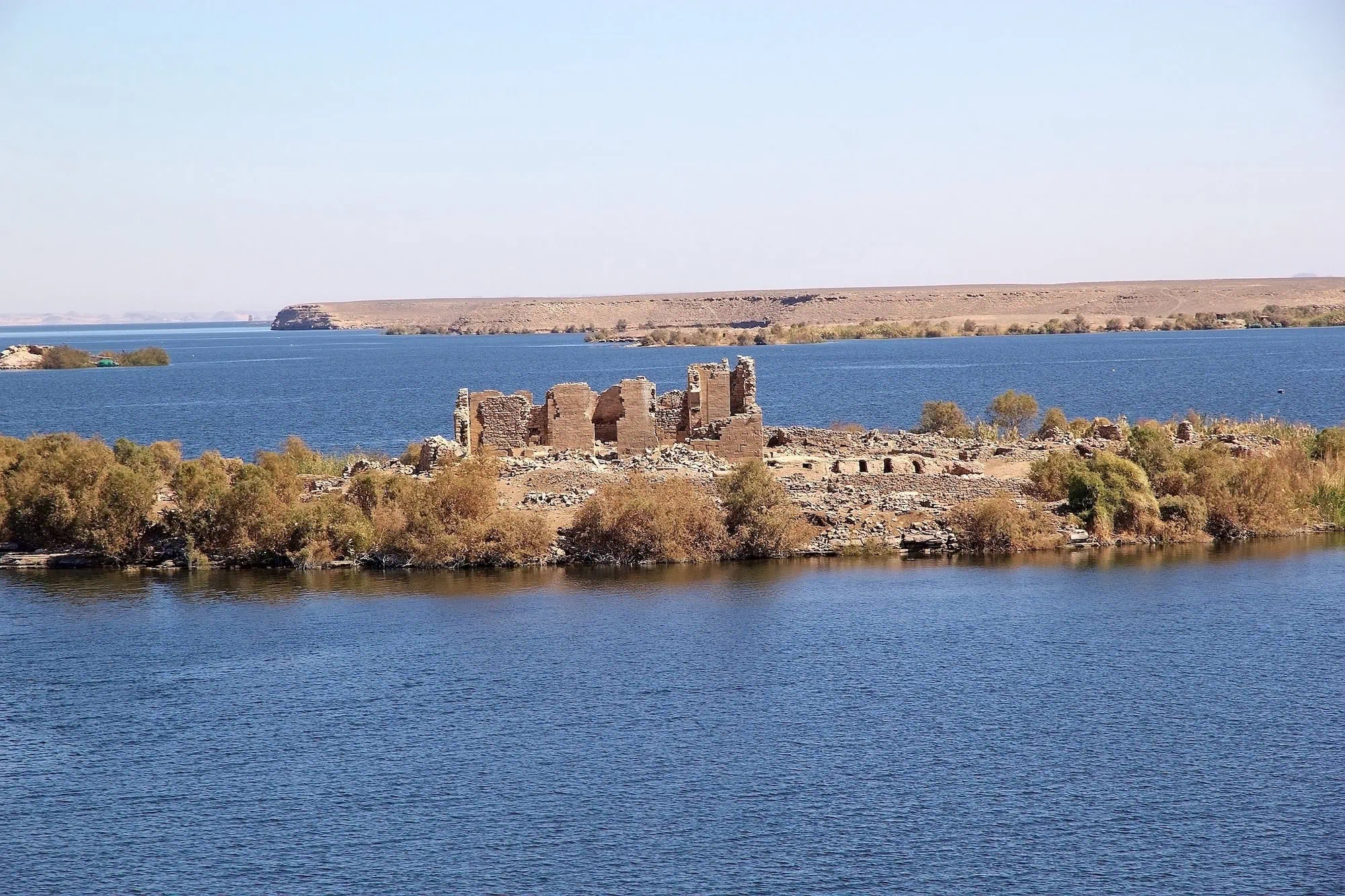 Kalabsha Temple ruins beside Lake Nasser showing ancient sandstone structures on an island