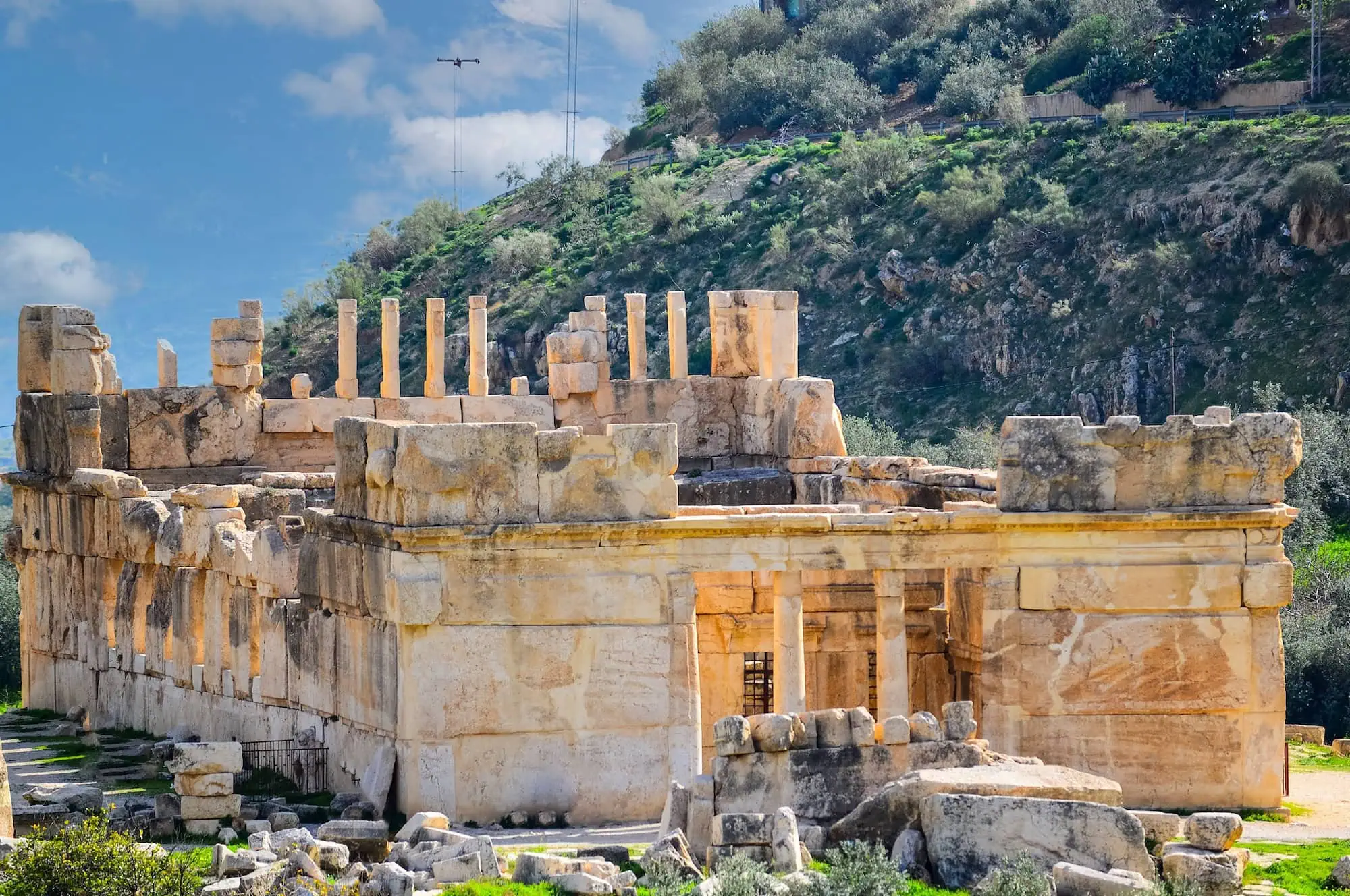 Ancient stone palace ruins of Qasr al-Abd with columns and limestone walls