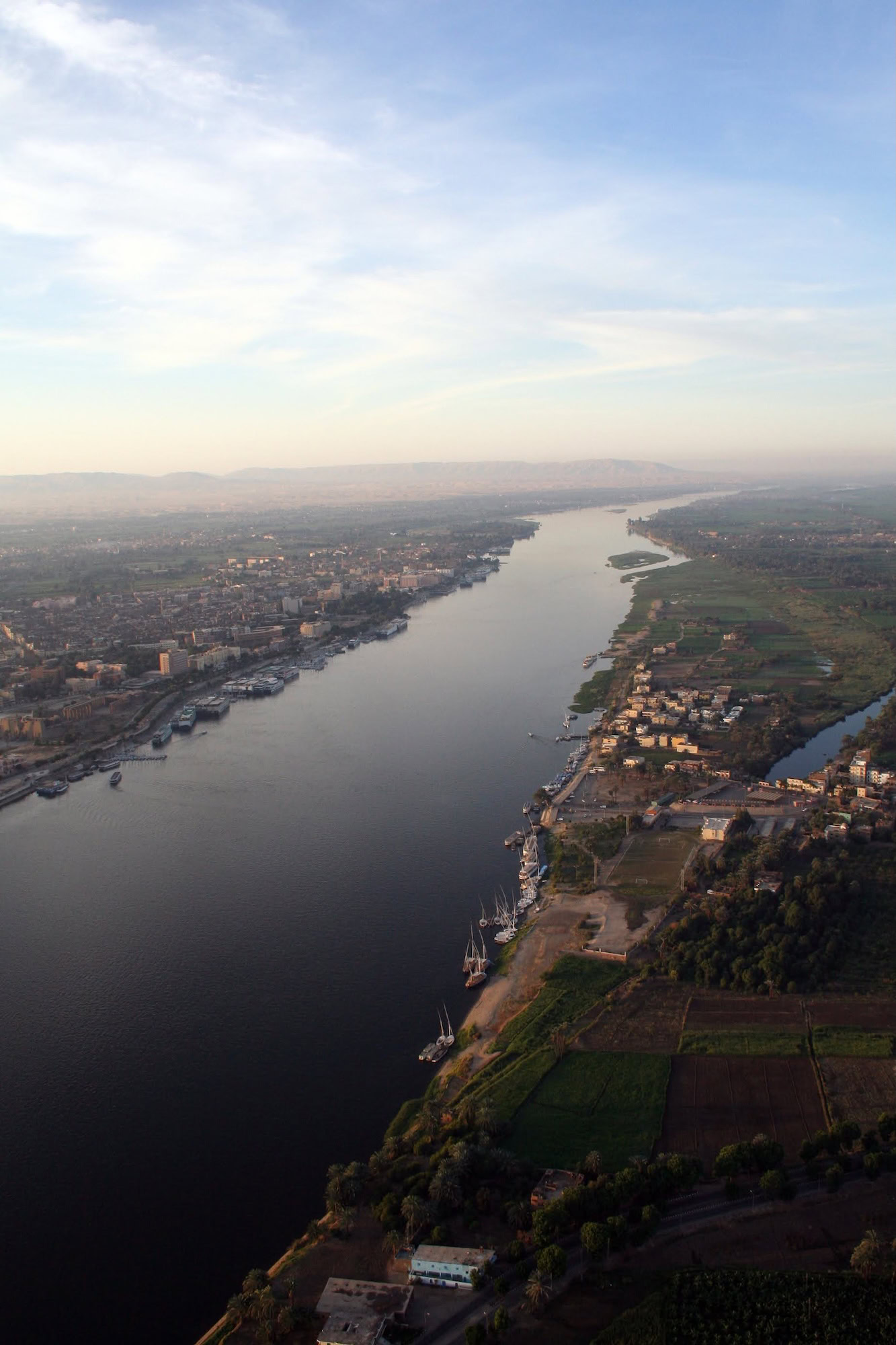 Aerial view of the Nile River with urban development and agricultural fields