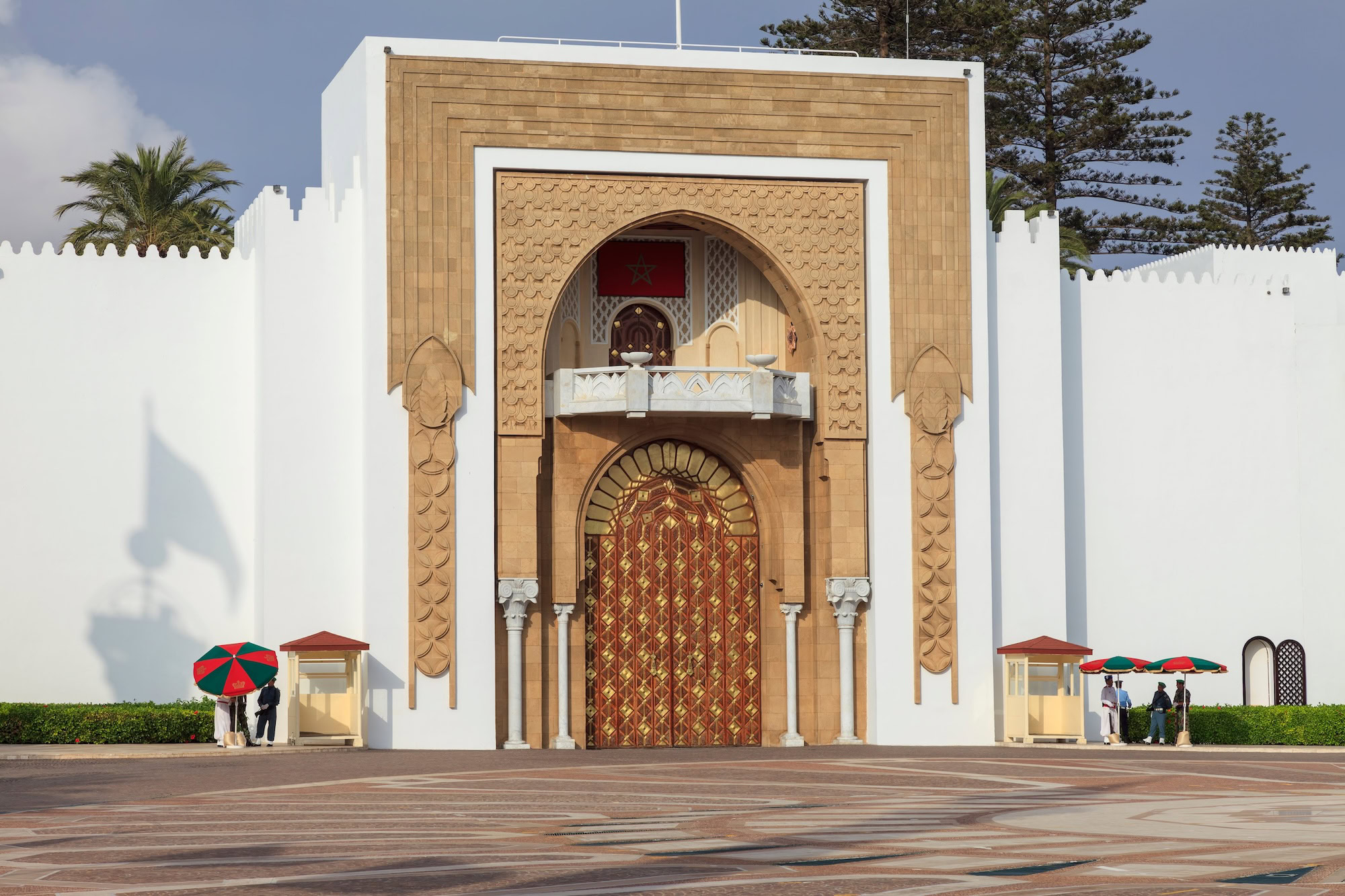 Hassan II Mosque in Casablanca with towering minaret, ornate entrance, and plaza with visitors
