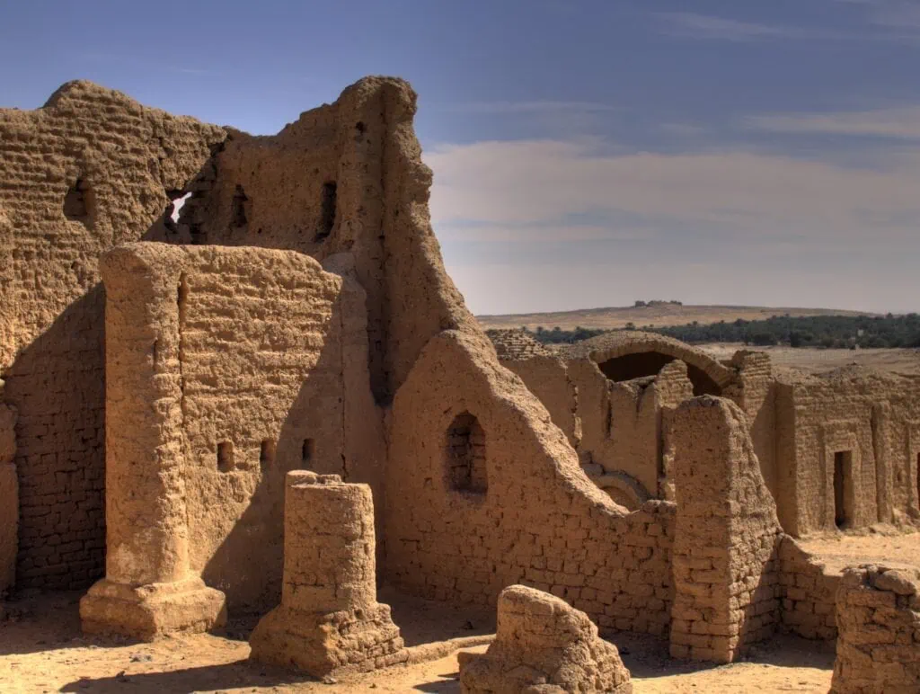 Al Bagawat desert ruin with mudbrick tomb structures and arched remains in Kharga Oasis
