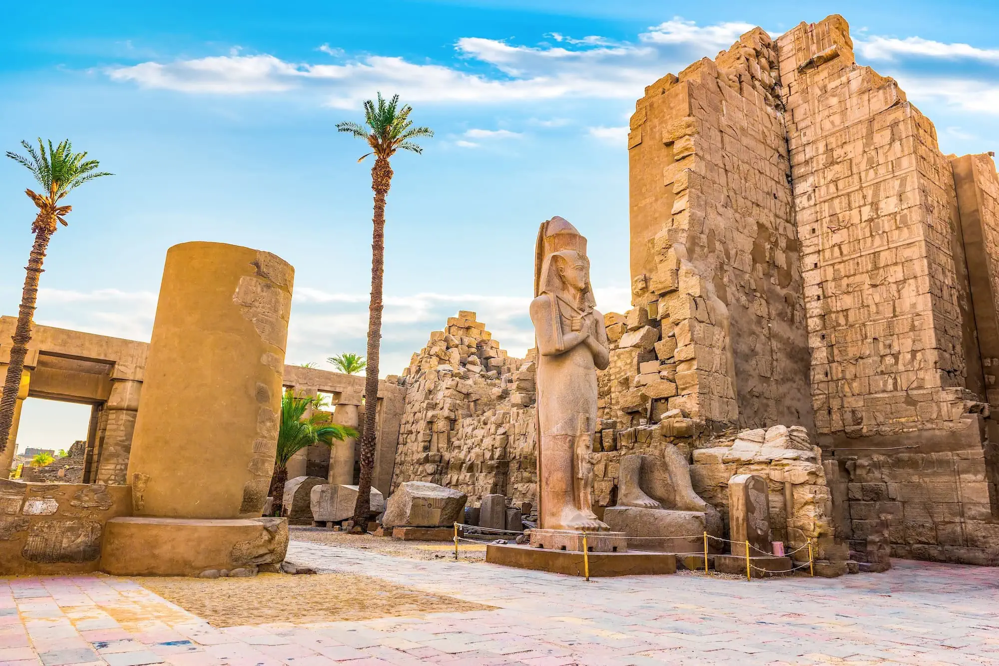 Ancient pharaoh statue and temple ruins at Karnak Temple Complex in Luxor