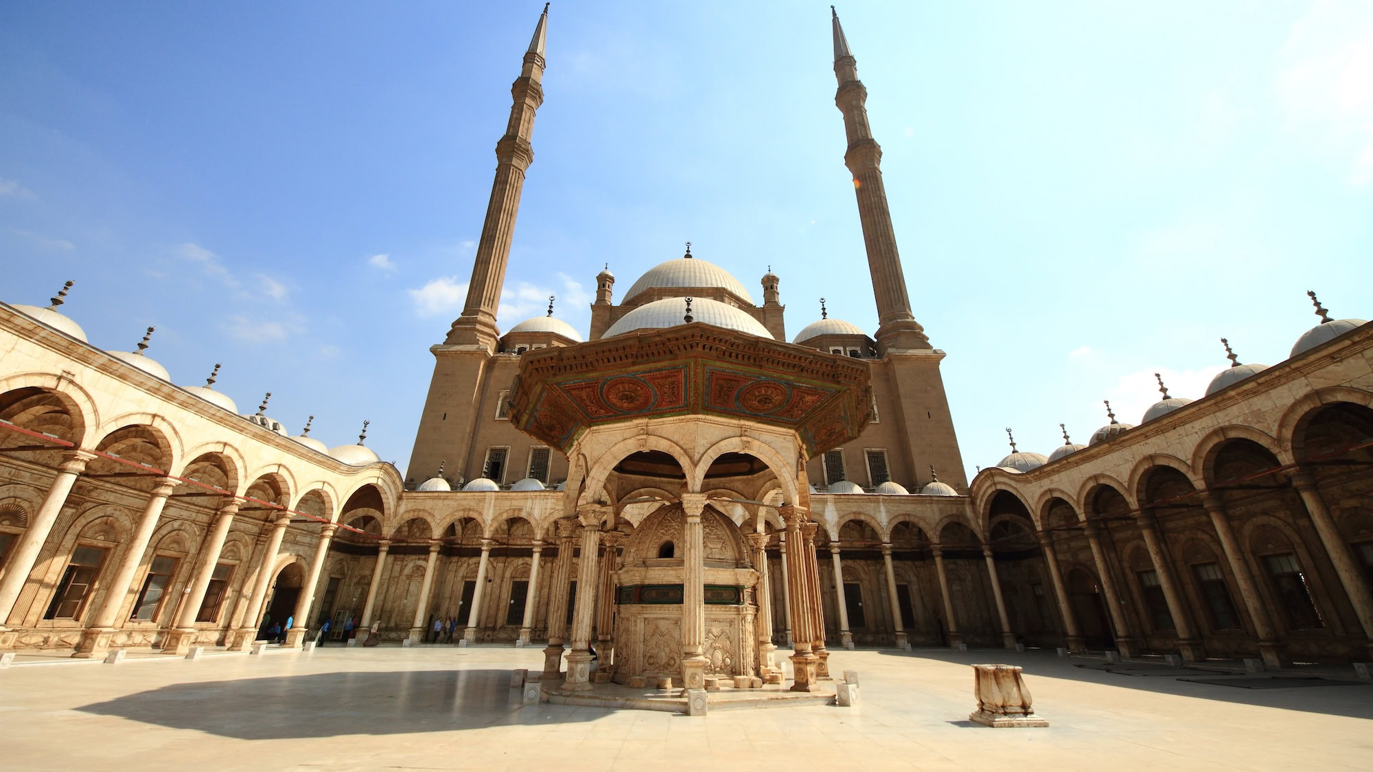 Majestic courtyard of Muhammad Ali Mosque with fountain, columns and minarets in Cairo