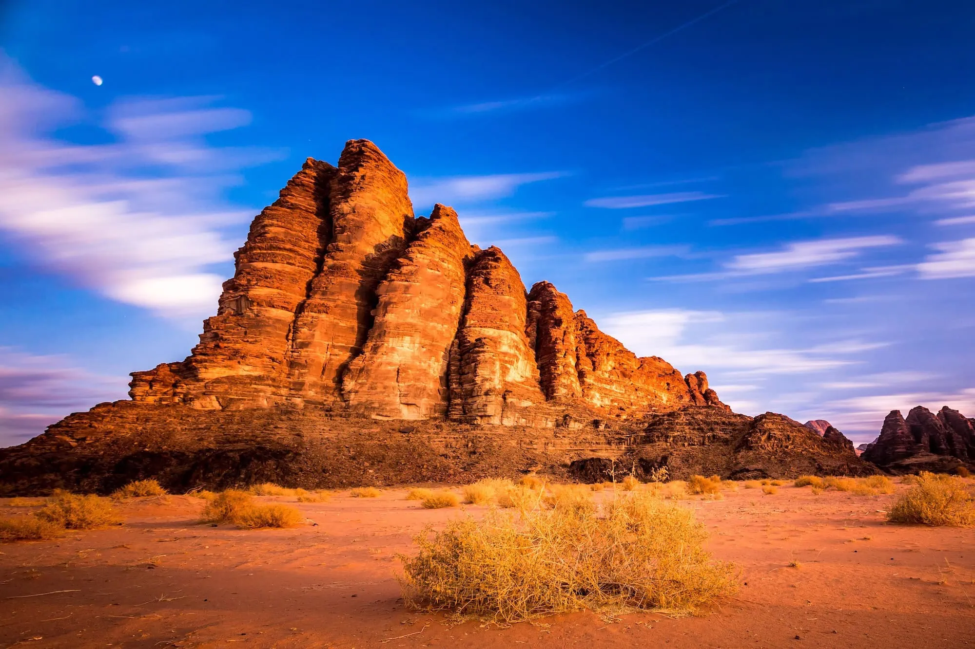 Seven Pillars of Wisdom rock formation in Wadi Rum Desert at sunset