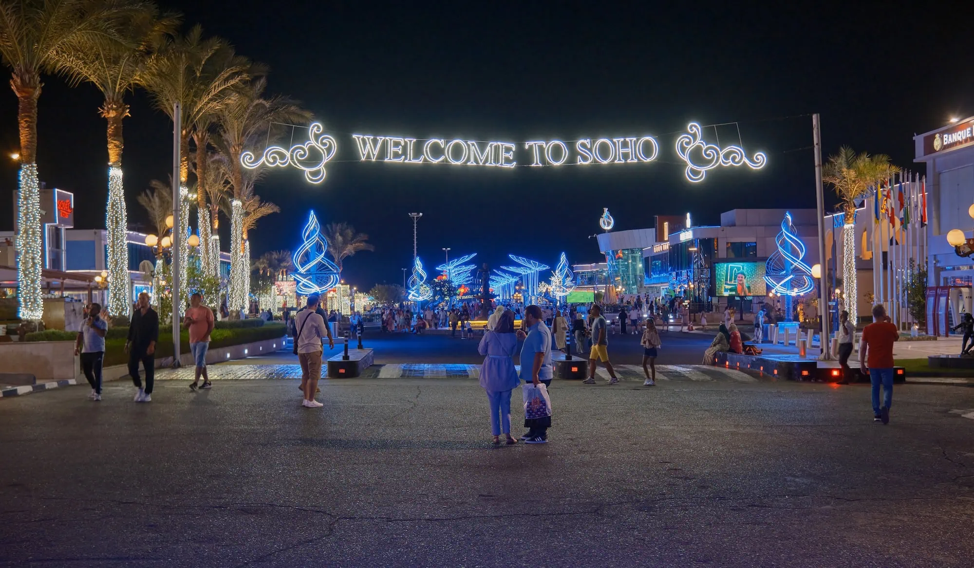 Nighttime view of SOHO Square shopping complex in Sharm El Sheikh with illuminated welcome sign