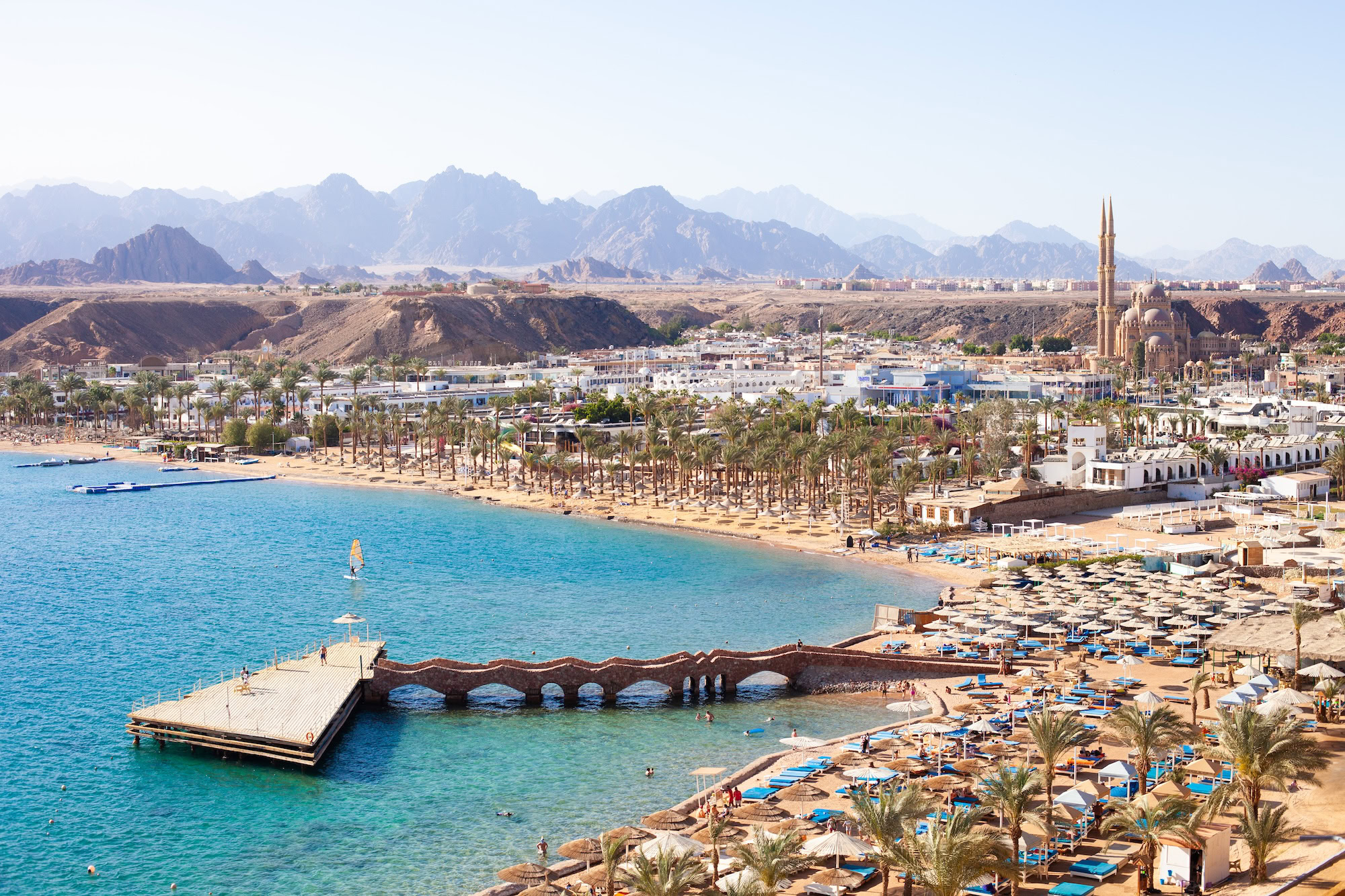 Sharm El Sheikh Red Sea resort with beach, stone bridge, mountains and boats