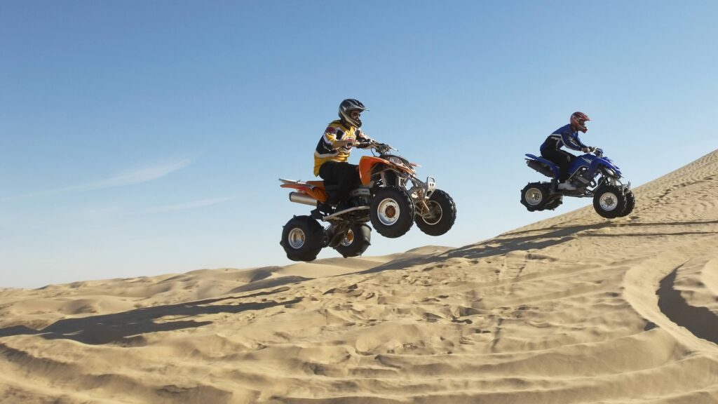Quad bikes driving across a sandy desert near Sharm El Sheikh