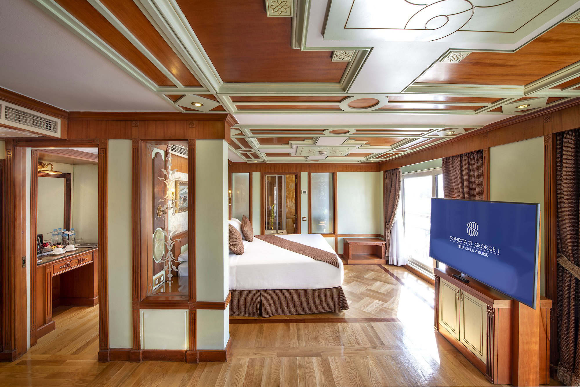 Luxurious cruise ship cabin interior with wooden paneling and elegant furnishings