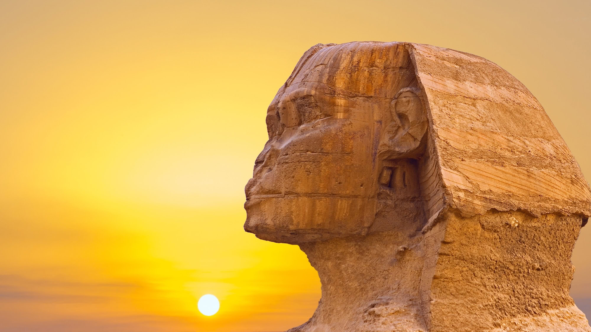 Majestic Great Sphinx of Giza illuminated by sun against ancient monument backdrop