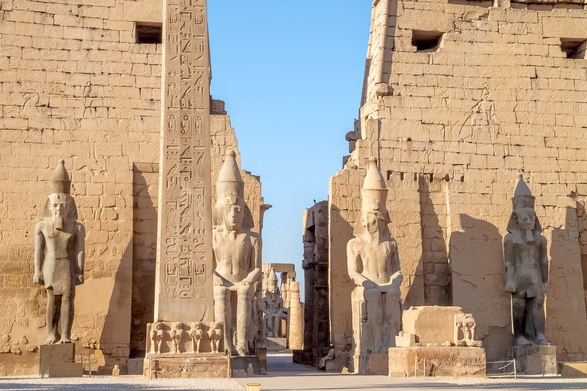 Ancient Luxor Temple with pharaoh statues, obelisk, and hieroglyphic columns in Egypt