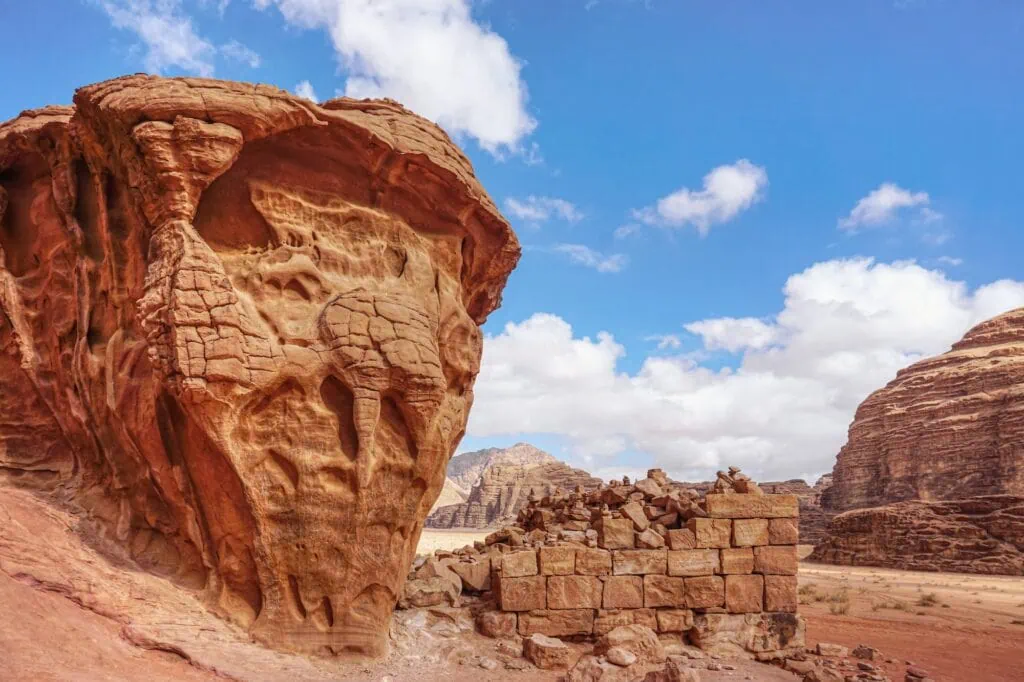 Stone brick wall remains against rocky cliffs near Lawrence's Spring, Wadi Rum