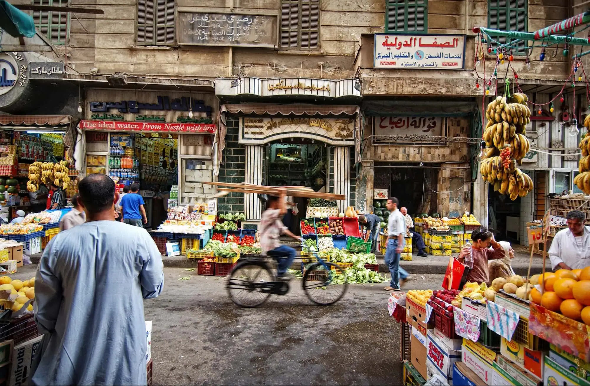 Egyptian market vendors selling fruits and vegetables on a traditional street