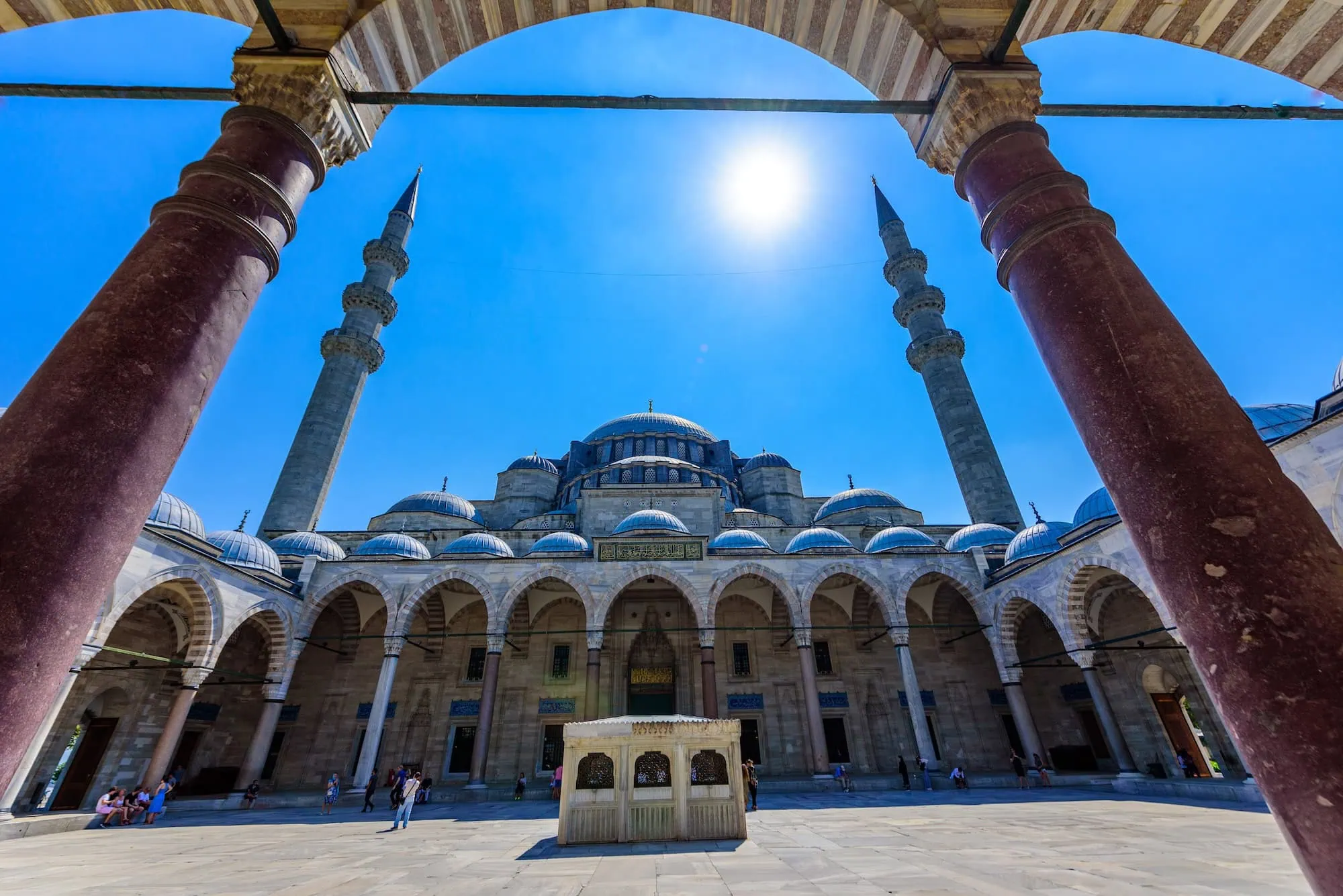 Suleymaniye Mosque courtyard in Istanbul showing Ottoman architecture with domes, minarets and fountain