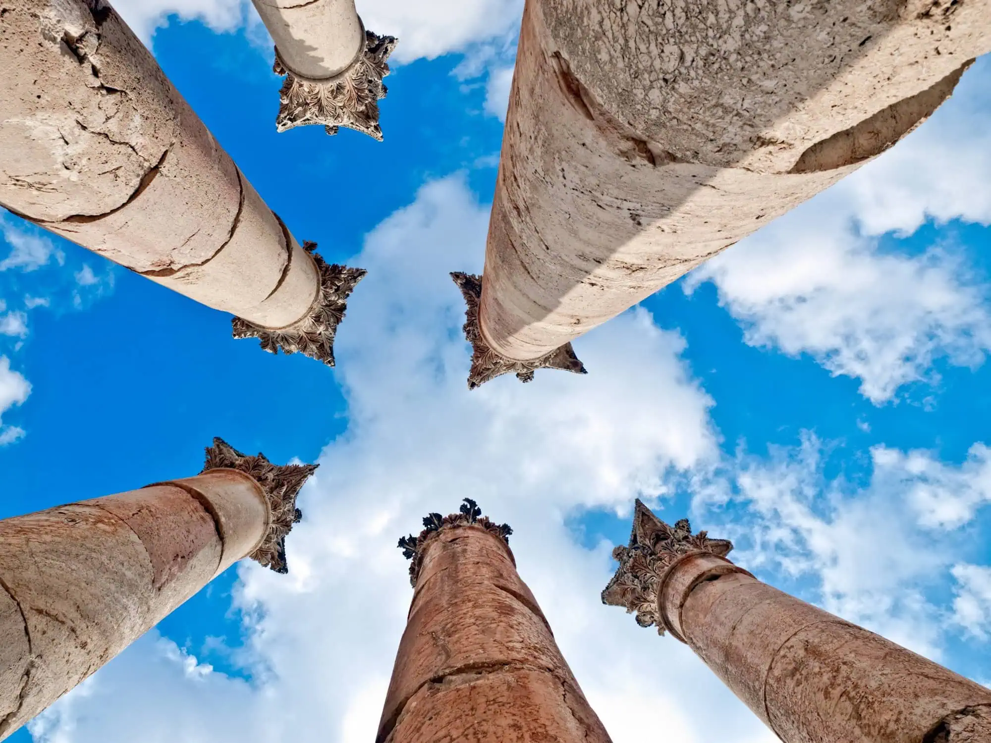 Ancient Corinthian columns of Temple of Artemis in Jerash against blue sky