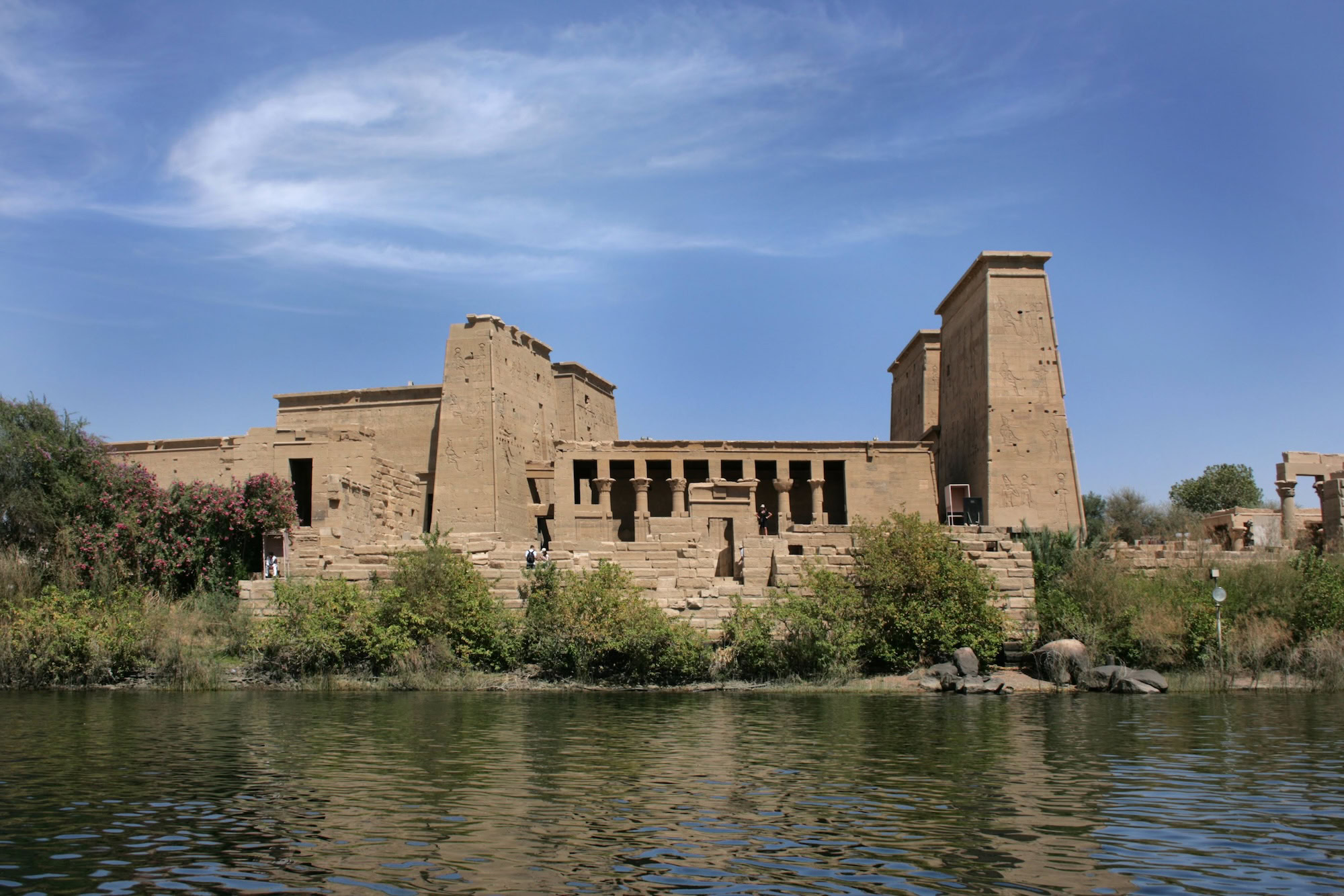 Ancient Philae Temple with sandstone columns reflected in the Nile River waters