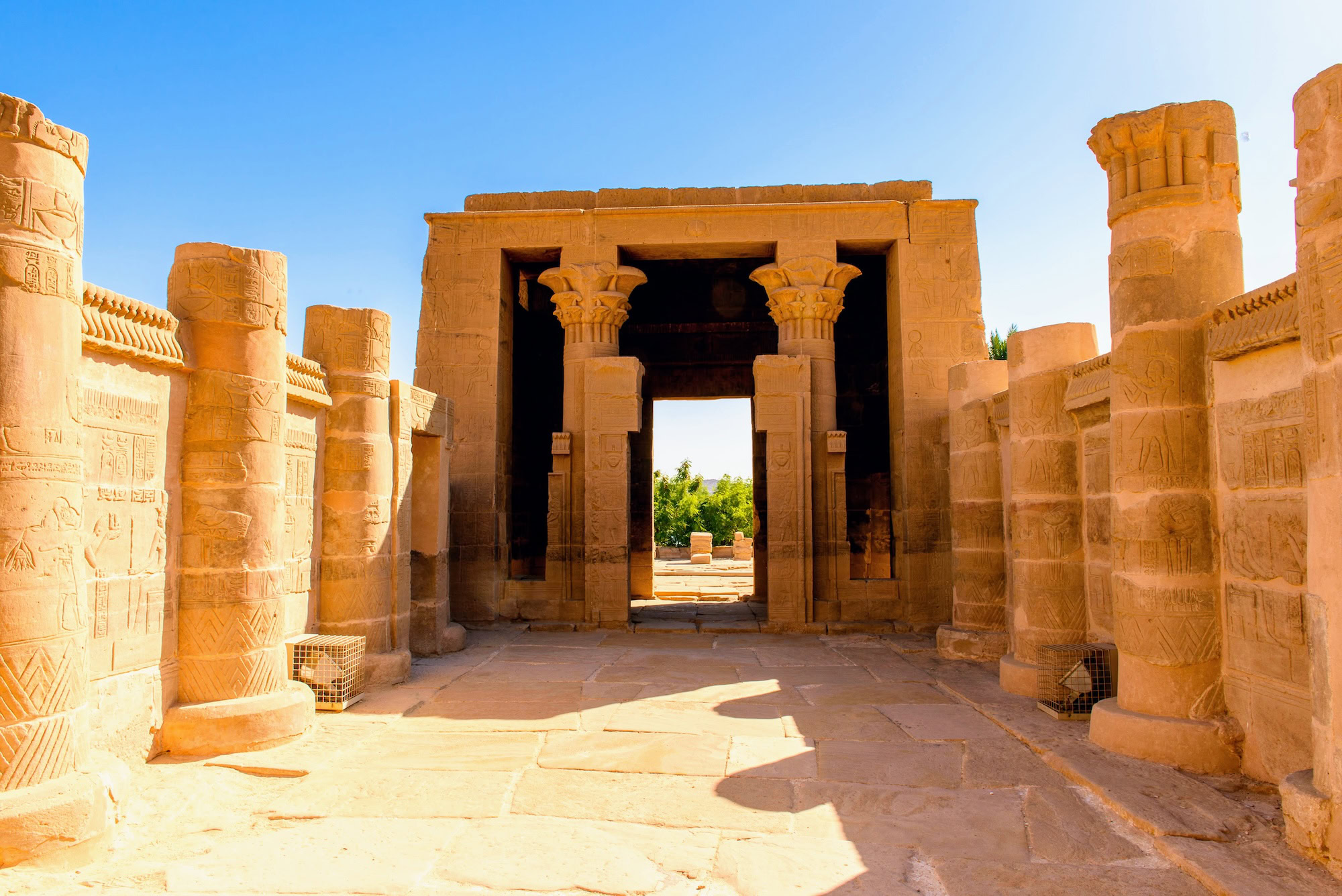 Ancient Kom Ombo Temple showing stone columns, hieroglyphic carvings, and courtyard entrance