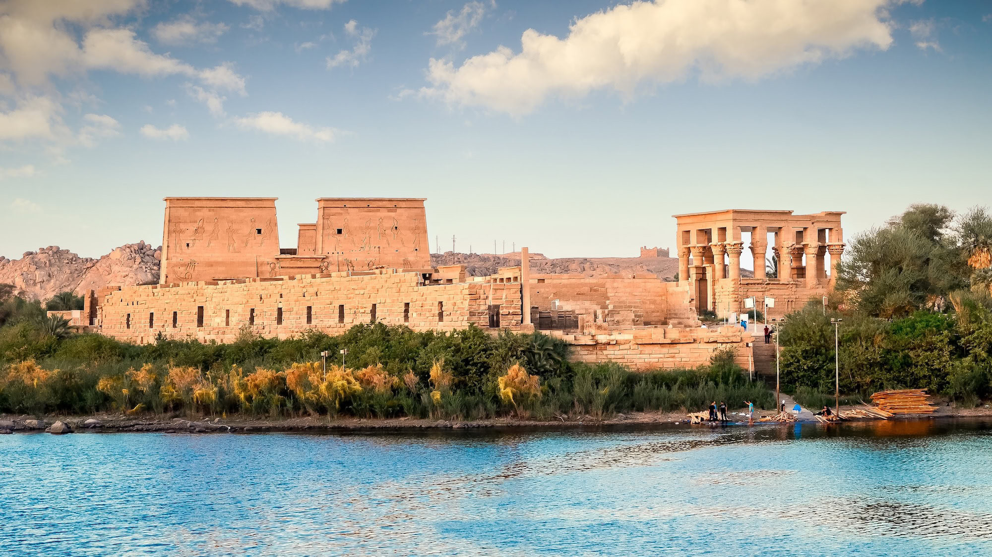 Philae Temple (Isis Temple) on the Nile River with tourist boats in Aswan, Egypt