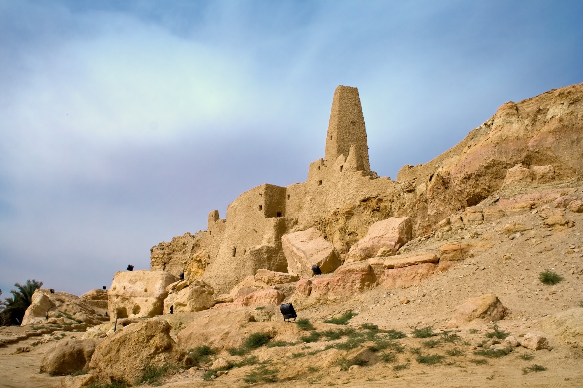 Ancient ruins of the Temple of the Oracle at Siwa Oasis showing weathered mud-brick structures