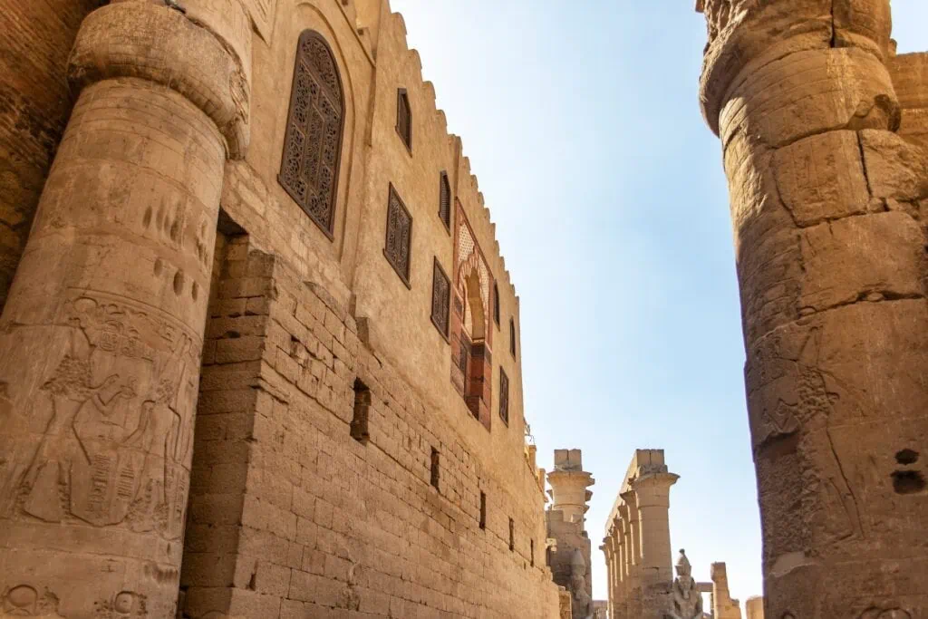 Stone columns with carved reliefs beside the Abu Haggag Mosque integrated into the Luxor Temple complex, Luxor