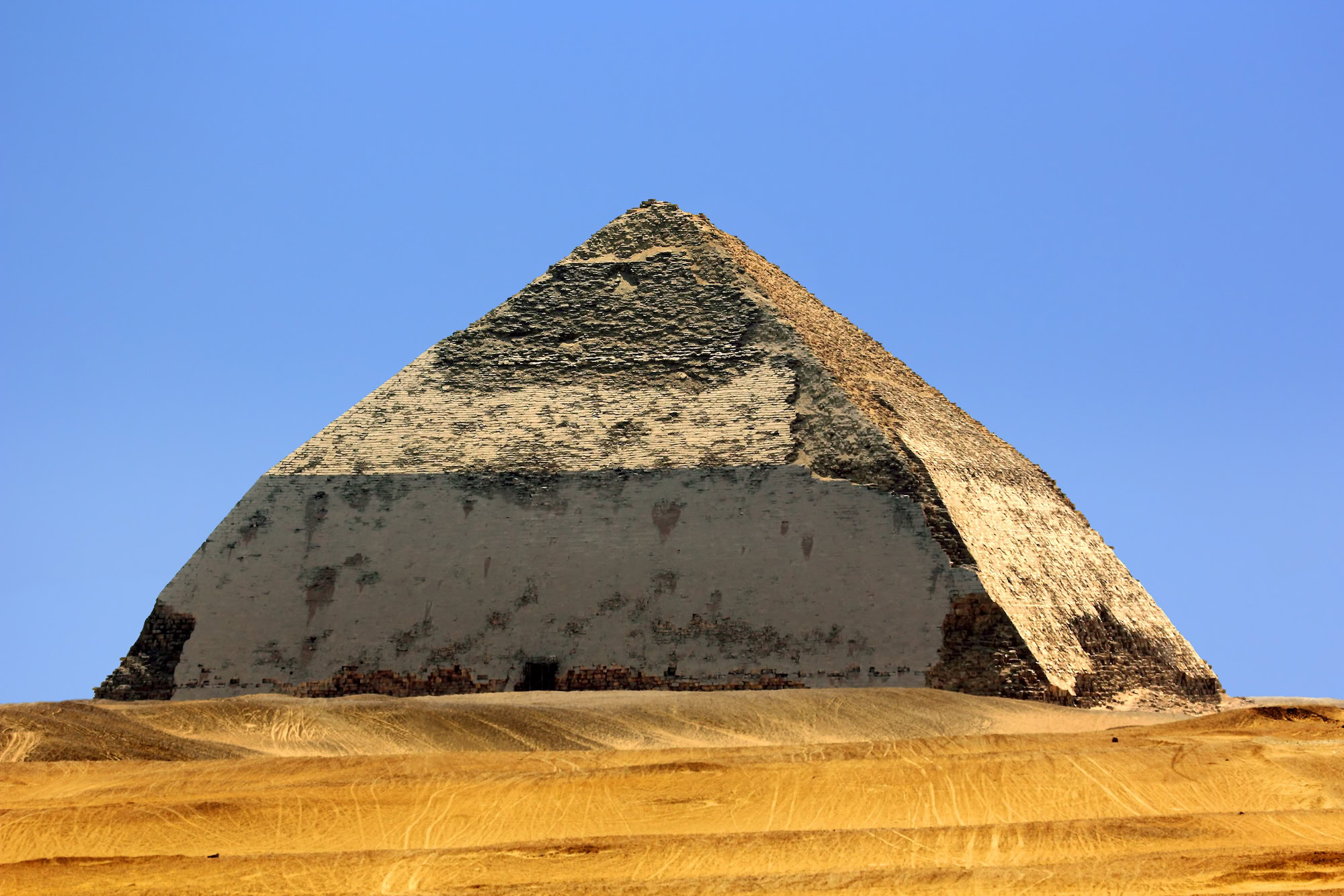 Ancient Bent Pyramid at Dahshour showing limestone construction and desert setting