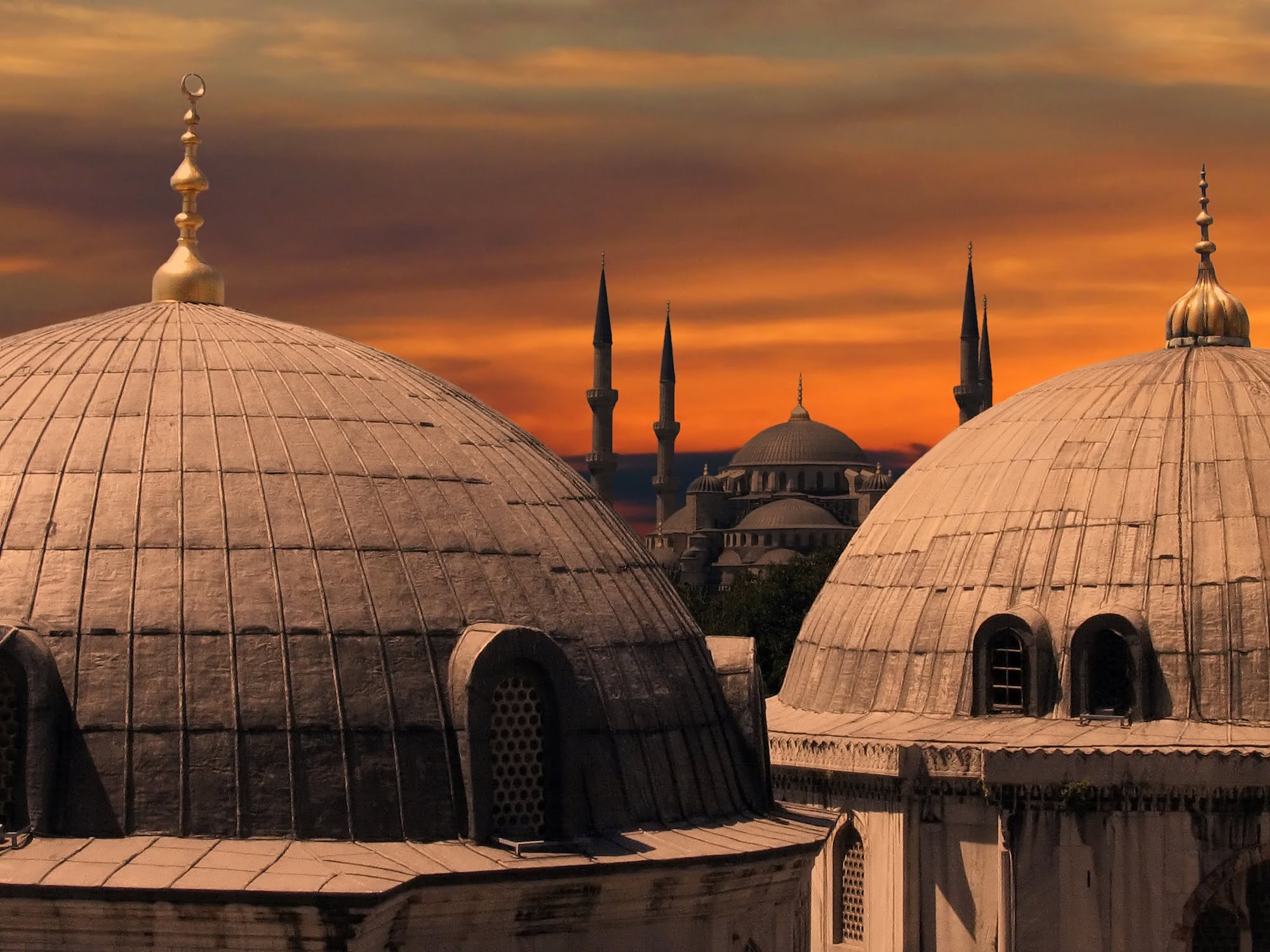 Blue Mosque with six distinctive minarets against sunset sky in Istanbul