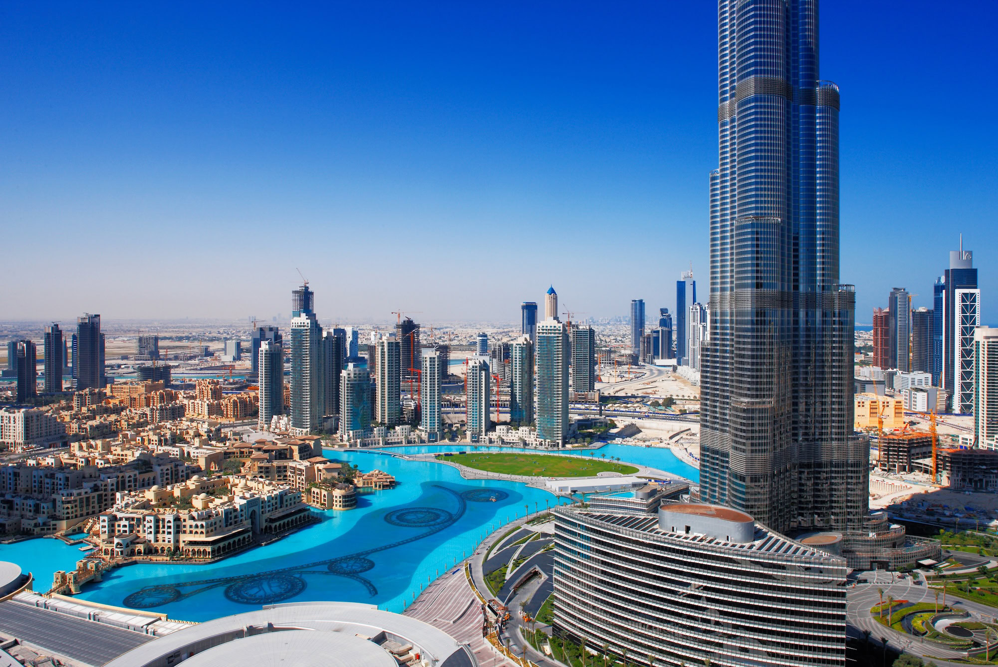 Aerial view of Burj Khalifa skyscraper with artificial lake and fountain in Dubai