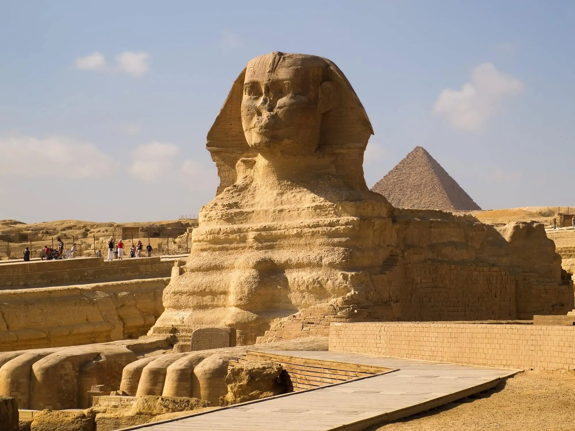 Tourists visiting the Great Sphinx of Giza with pyramid in background