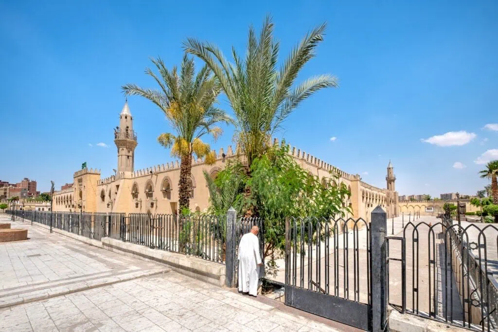A Muslim man entering through an arched doorway into the Mosque of Amr ibn al-As in the Fustat area, Cairo