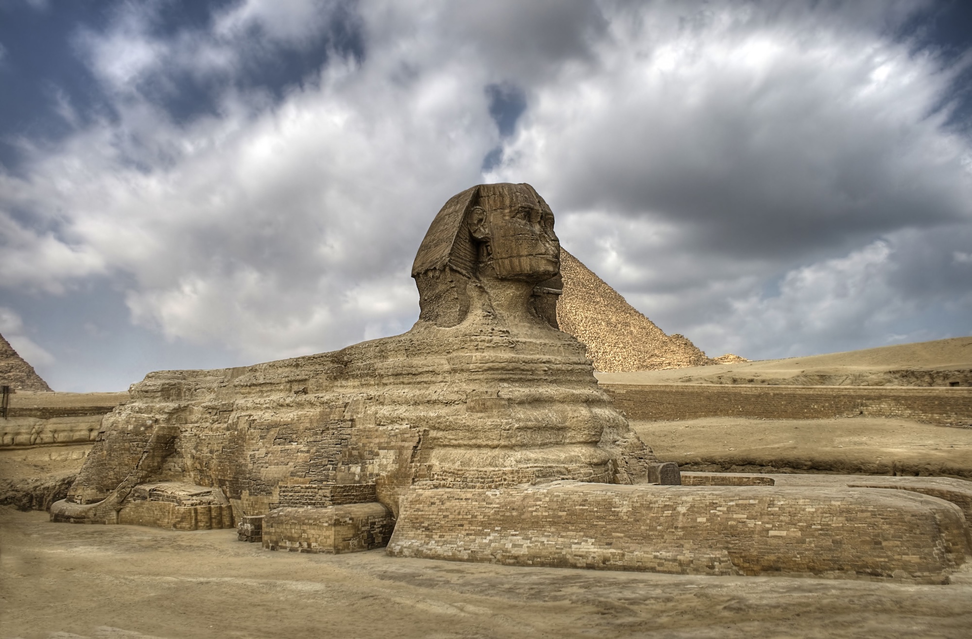 The Great Sphinx of Giza with pyramid in background at the Giza Necropolis