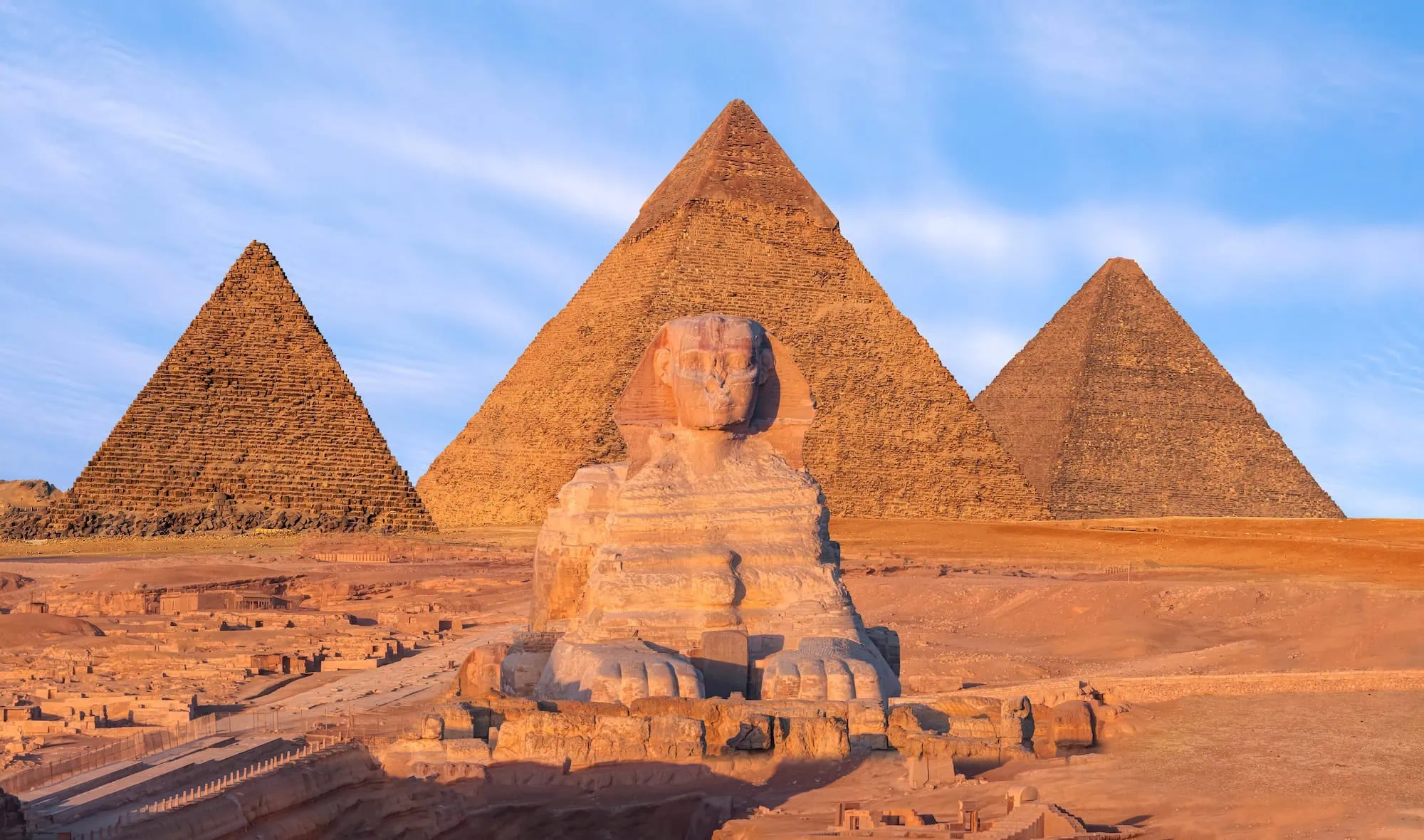 The three Pyramids of Giza and the Great Sphinx in the desert outside Cairo, the standard first stop on Egypt tours with Nile cruise before flying south to Luxor to begin the 4-day Luxor–Aswan cruise.