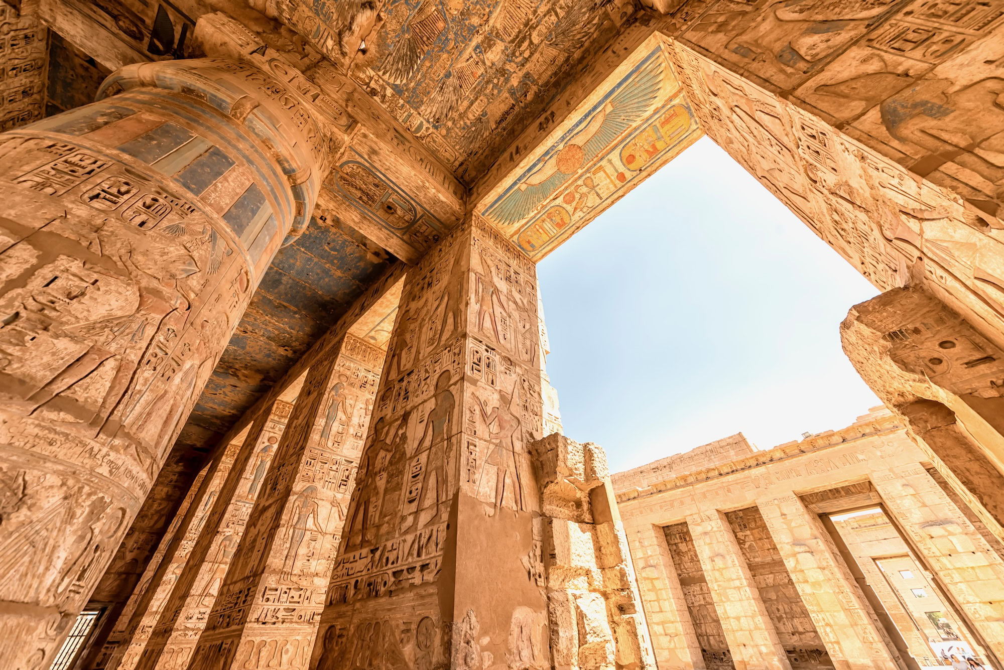 Ancient Egyptian temple interior with hieroglyphic carvings and columns showcasing cosmological architecture
