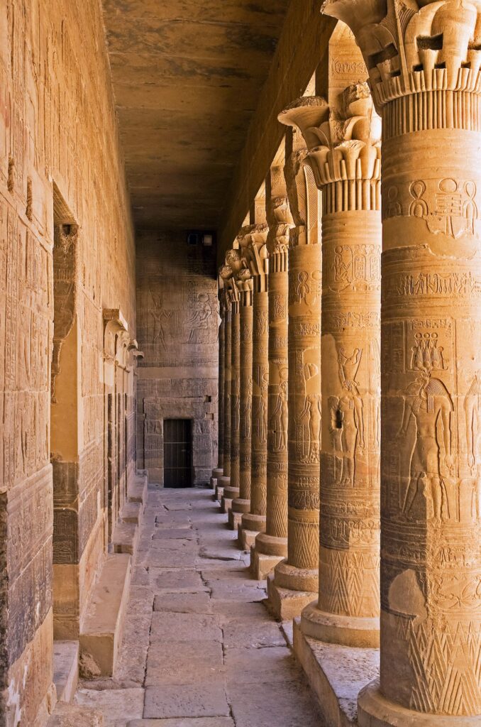 Ancient columns of Philae Temple rising beside the Nile near Aswan