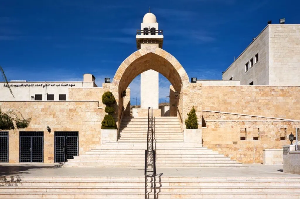 Mosque structure at the Cave of the Seven Sleepers with Arabic signage in Amman