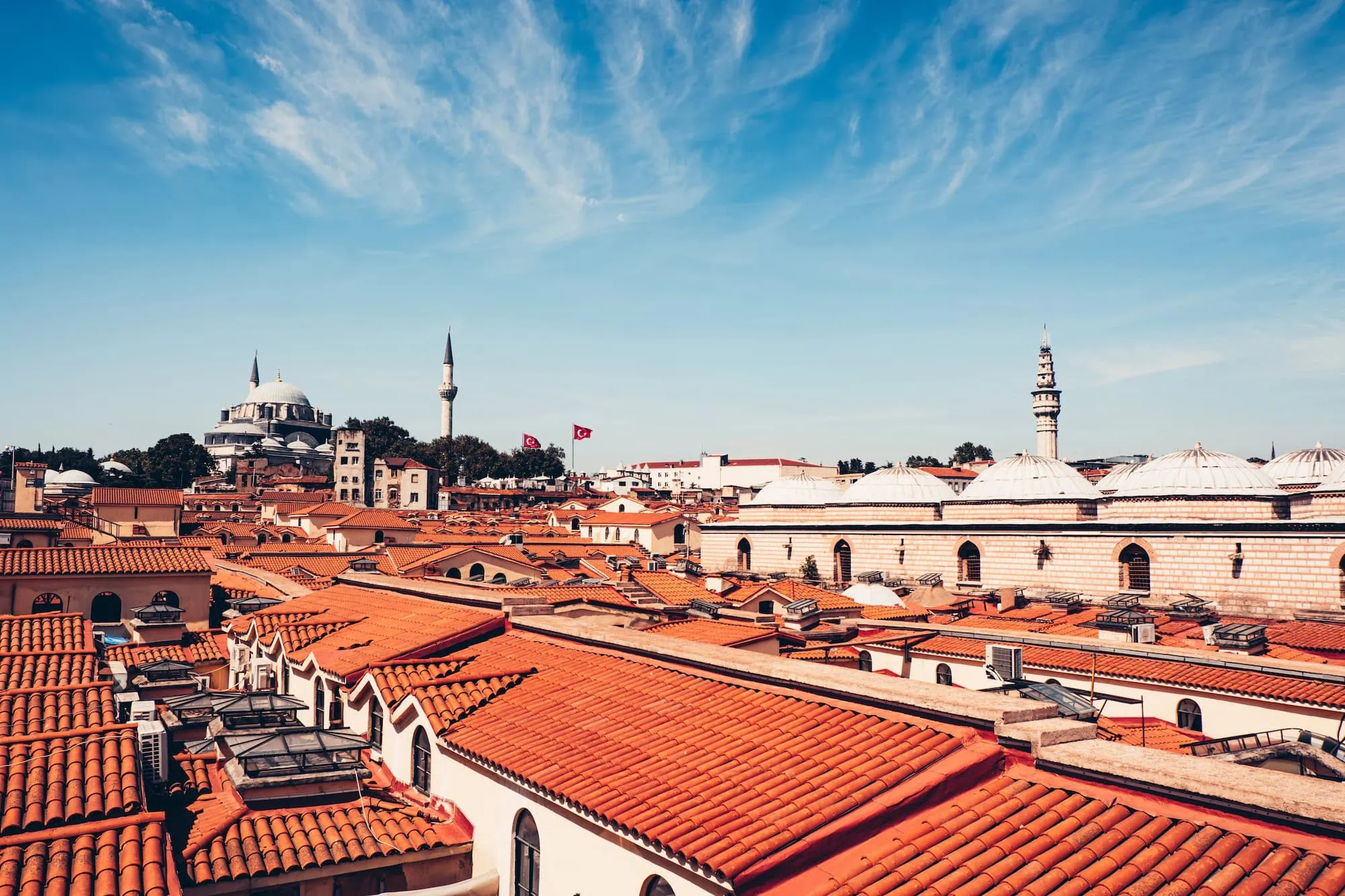 Aerial view of Grand Bazaar's red rooftops in Istanbul with Ottoman architecture and minarets