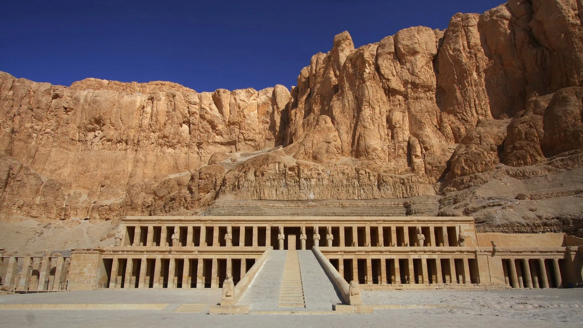 Terraced facade of Hatshepsut’s Mortuary Temple built into limestone cliffs at Deir el-Bahari, Luxor