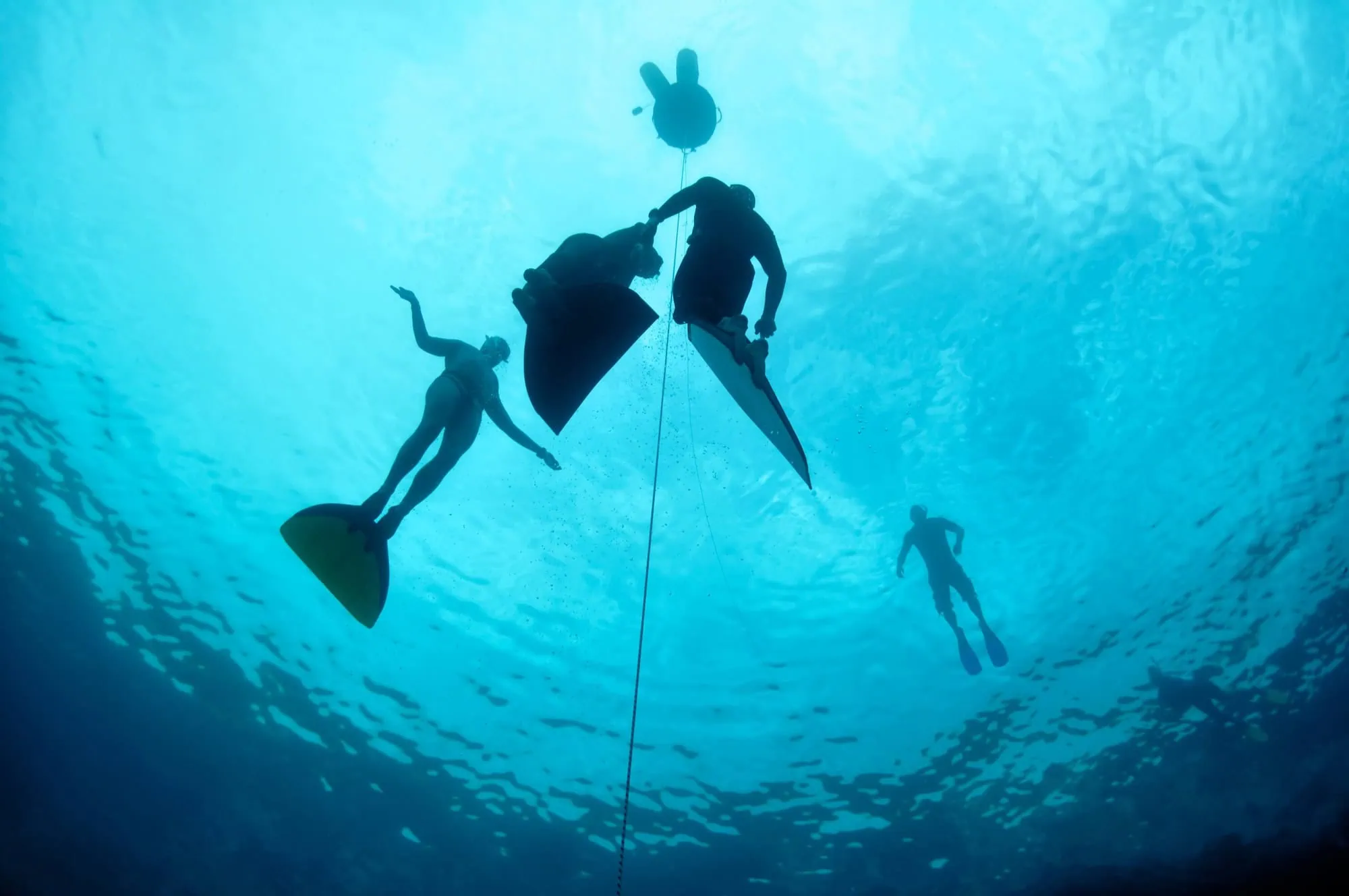 Divers exploring underwater in the famous Blue Hole diving site