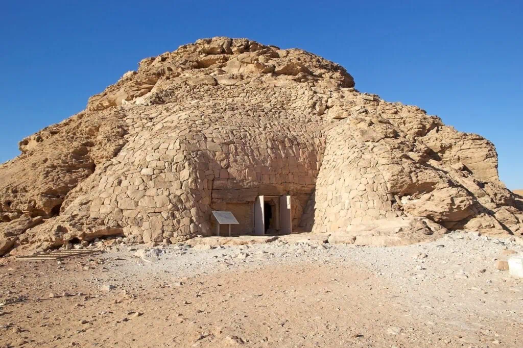 Entrance to the Tomb of Pennut with carved stone doorway and surrounding rock-cut walls, Aswan