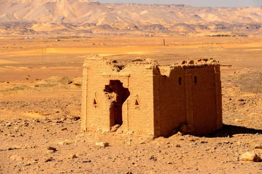 Tomb of the Al-Bagawat with mudbrick chapels and domed structures spread across a desert cemetery in Kharga Oasis