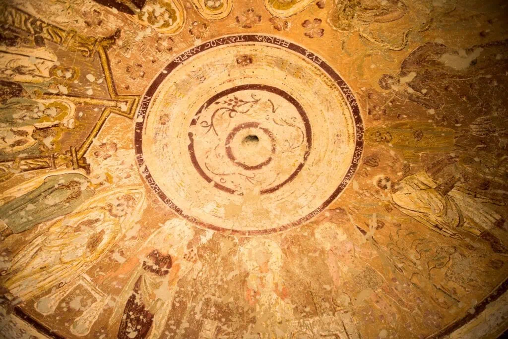 Al Bagawat tomb chapel interior with circular dome and faded wall paintings in Kharga Oasis