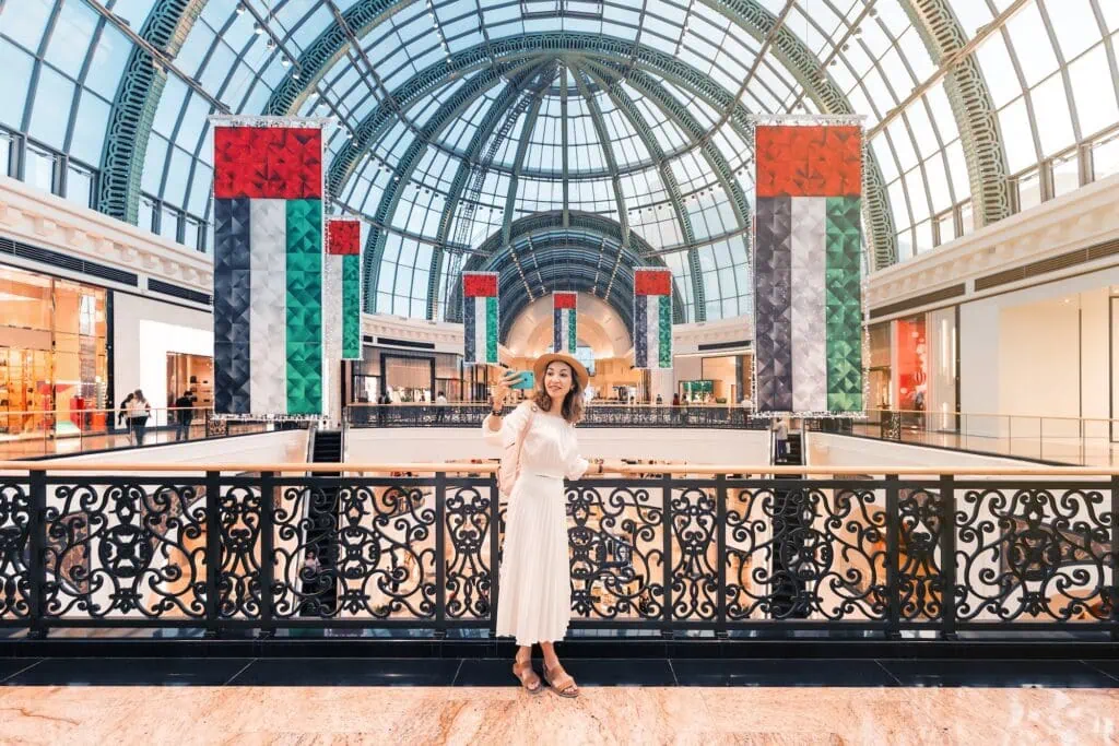 Interior view of Mall of the Emirates with retail corridors and a visitor taking a selfie, Dubai