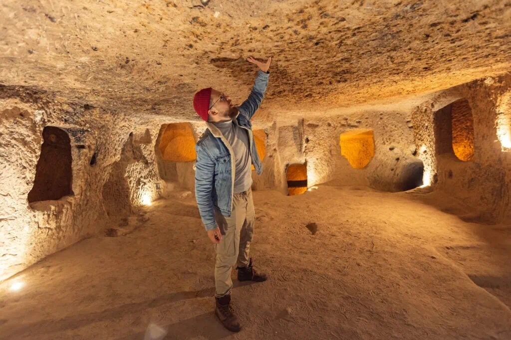 Kaymakli Underground City interior with carved rock rooms, low ceilings, and wall niches in Nevşehir