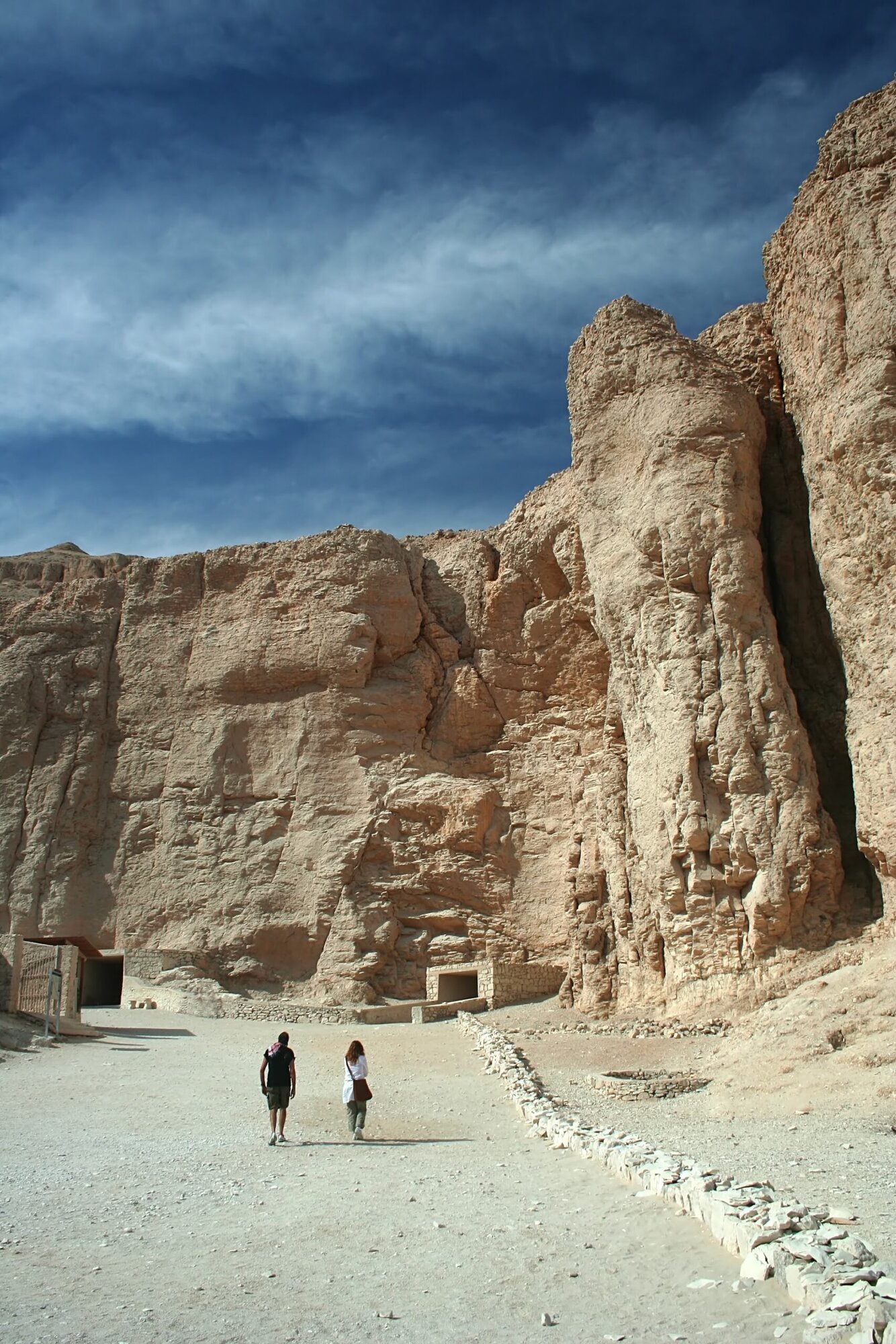 Tourists exploring ancient tombs pathway in Valley of the Kings, Egypt
