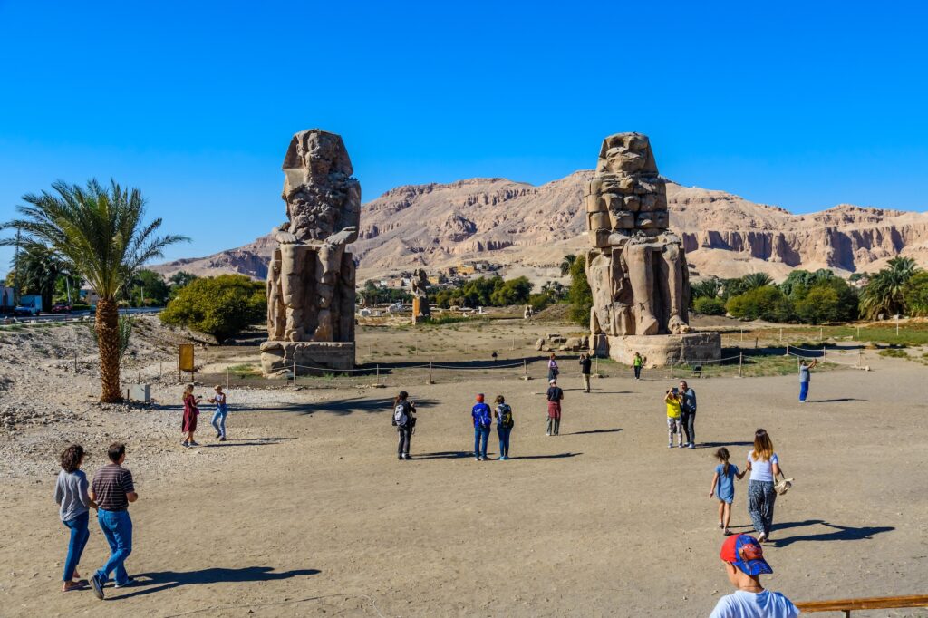 The Colossi of Memnon, a pair of immense ancient statues that once guarded the mortuary temple of Amenhotep II