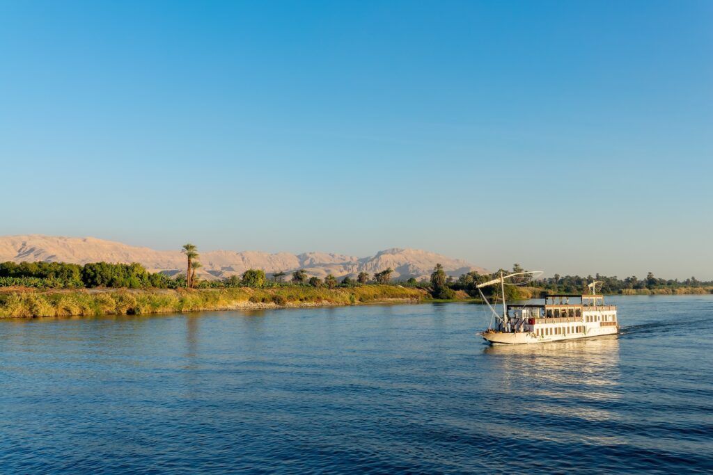 Traditional Egyptian Dahabiya boat cruising on the Nile River