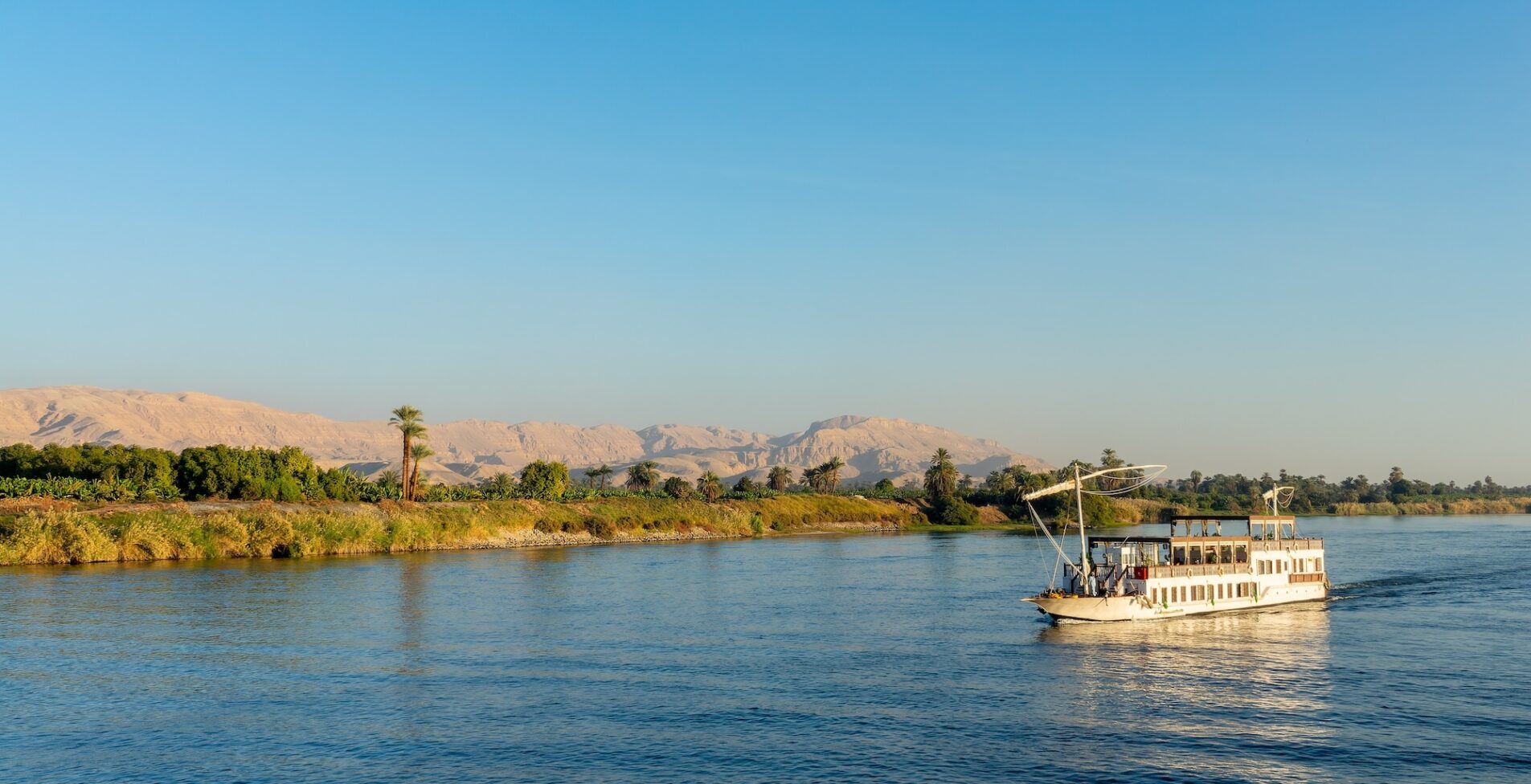 Traditional egyptian dahabiya boat cruising on the Nile river Egypt