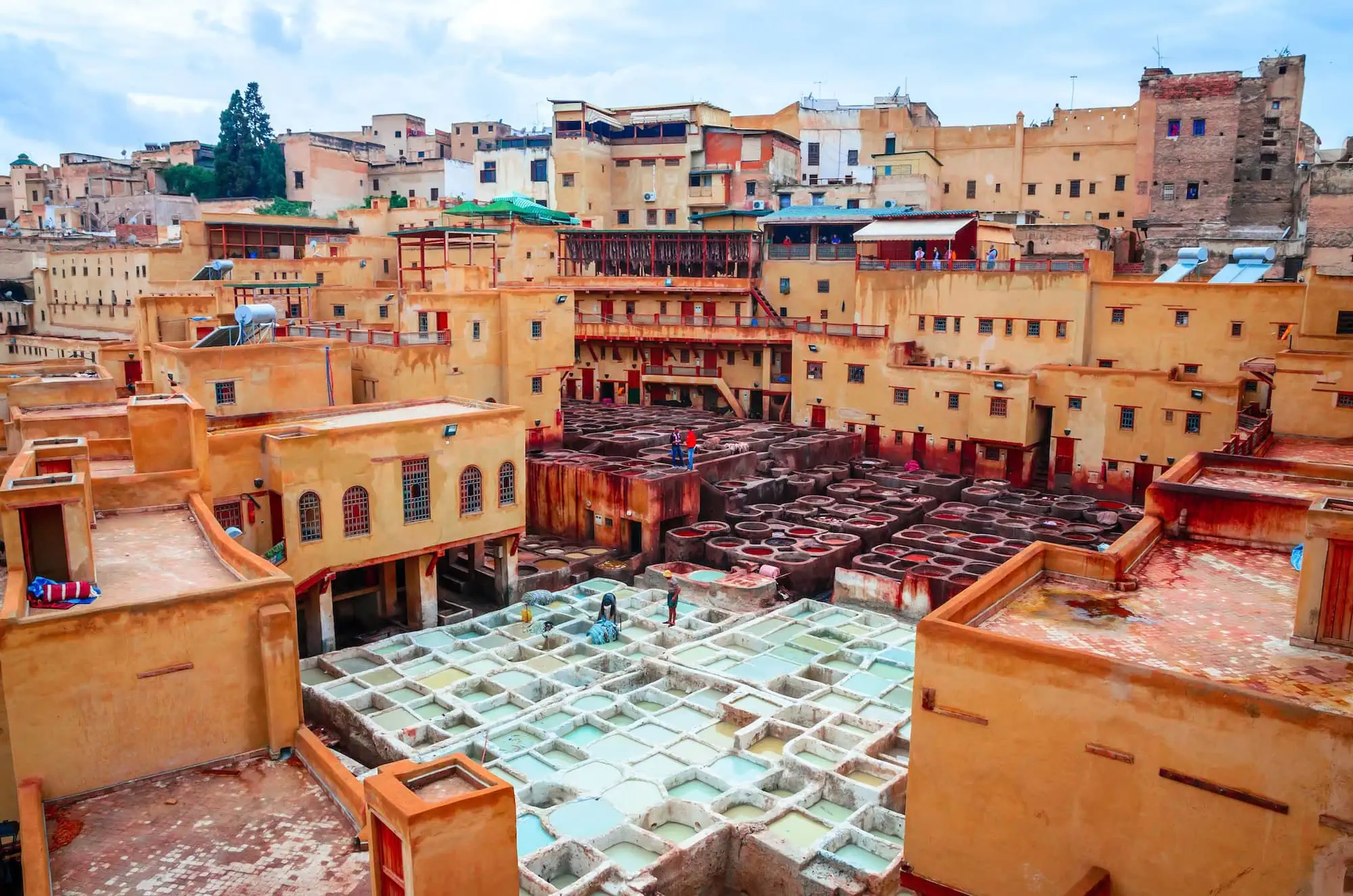 Traditional leather tannery in Fez showing colorful stone vats used for dyeing leather in the ancient medina