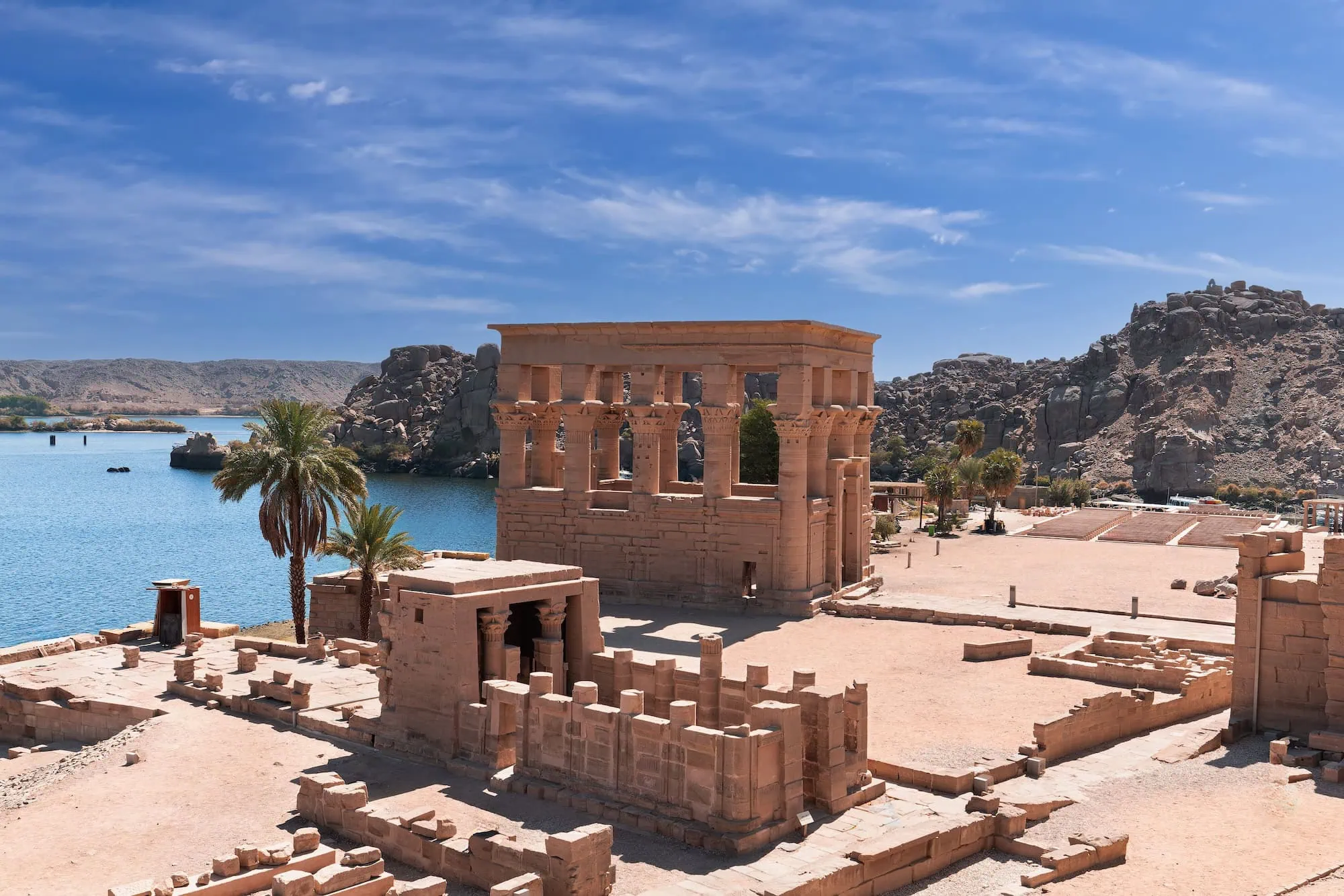 Ancient Temple of Philae with columns and stone ruins near water in Aswan