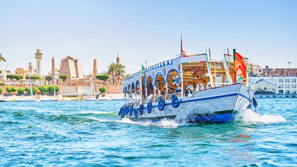 Trip boat cruising the Nile River in Luxor, Egypt – a scenic experience featured on Egypt tours from Denver.