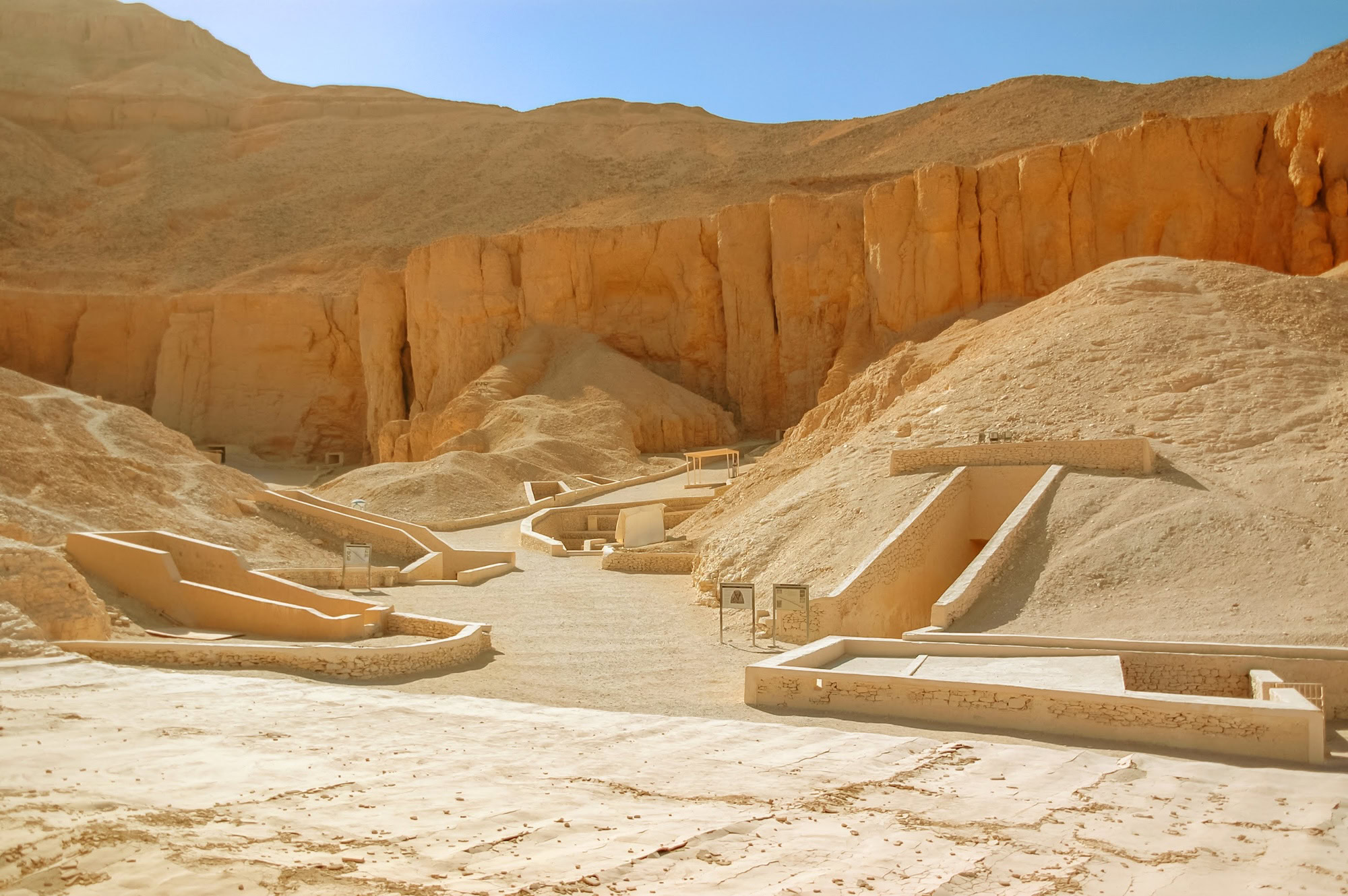 Valley of the Kings archaeological site with tomb entrances in limestone cliffs