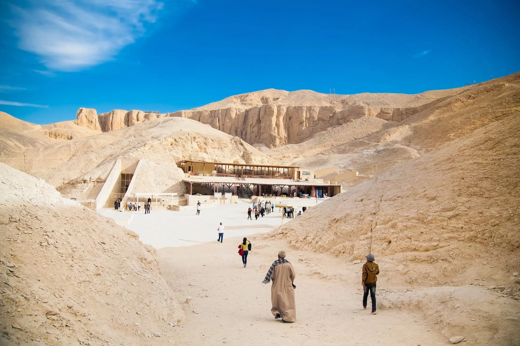 Tourists visiting archaeological site entrance at Valley of the Kings with modern visitor facilities